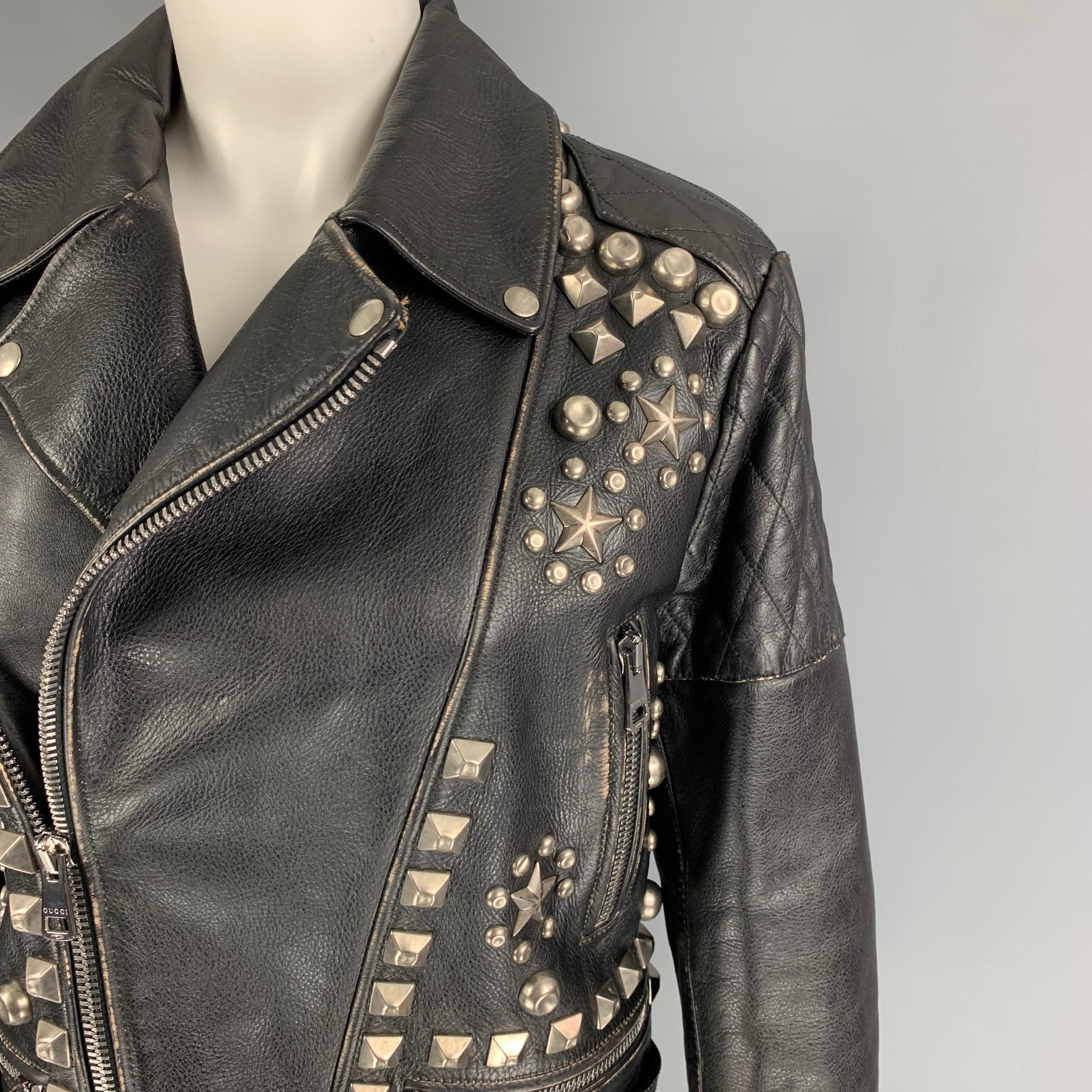 GUCCI SS 17 jacket comes in a black distressed leather with a red quilted embroidered lining featuring a biker style, quilted panels, silver tone studded details, front pockets, and a zip up closure. Made in Italy. 

New With Tags. 
Marked: