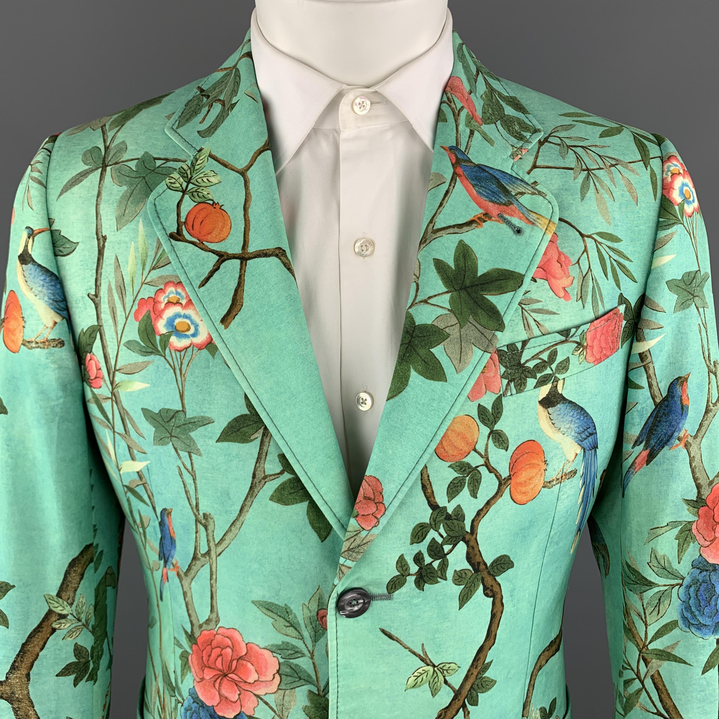 GUCCI Men's Spring Summer 2016 by Alessandro Michele Blazer Jacket / Sport Coat comes in a green heritage print cotton material, with a notch lapel, slit and patch pockets, two buttons at closure, single breasted, buttoned cuffs, a double vent at