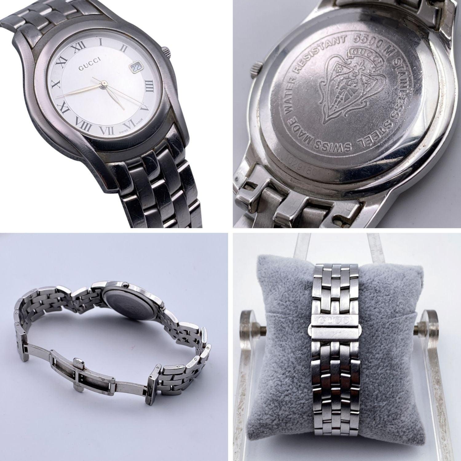 Gucci silver tone stainless steel wrist watch, mod. 5500 M. Silver Dial. Date at 3 o'clock. Sapphire crystal. Swiss Made Quartz movement. Gucci written on face. Roman numbers. Gucci crest on the reverse of the case. GUCCI logo engraved on the clasp.