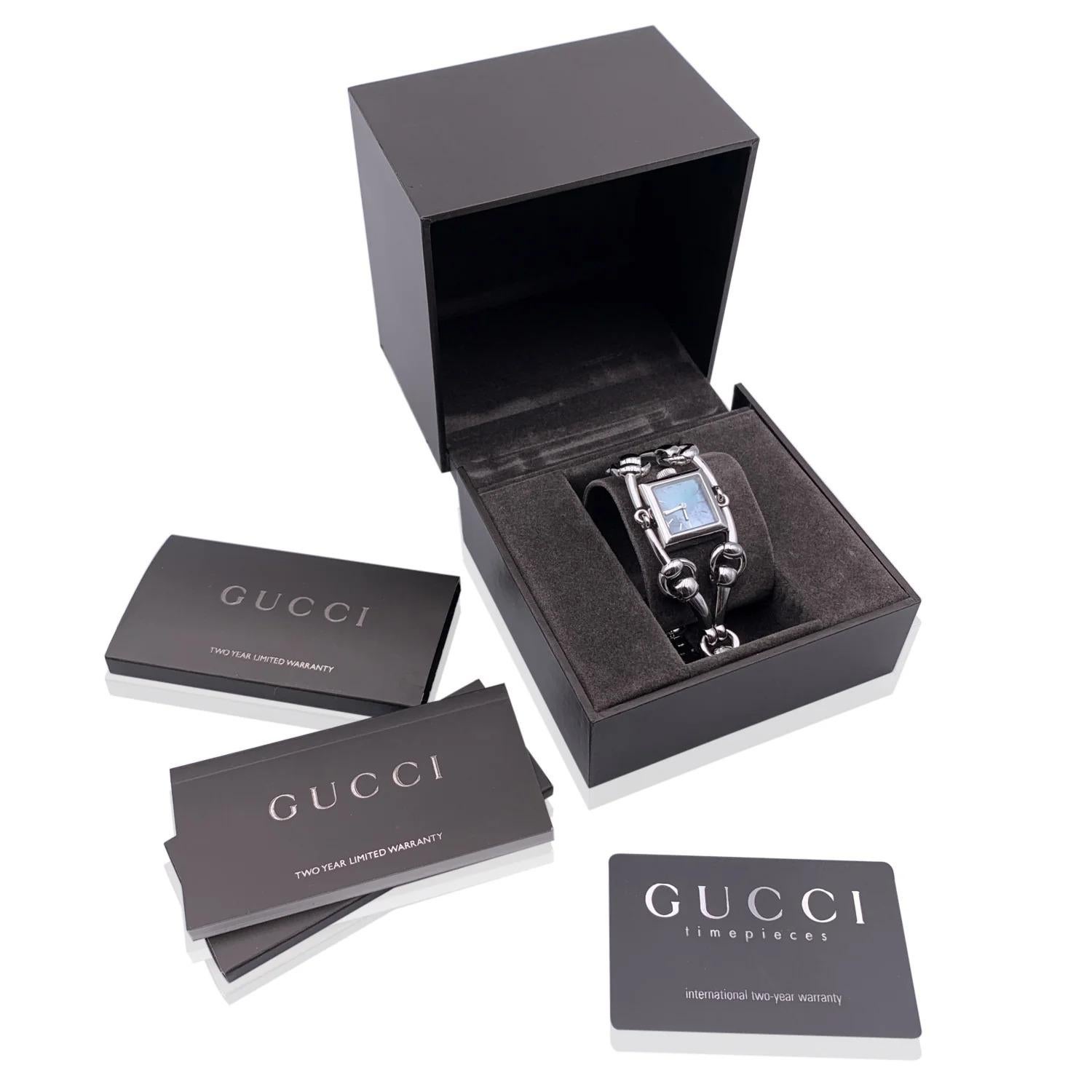 Gucci Mod. 'Signoria - 116.5' stainless steel wrist watch. Stainless steel case. Square mother of Pearl dial in blue color. Sapphire crystal. Swiss Made. Quartz movement. Horsebit bracelet. Gucci written on face, clasp and reverse. Will fit up to