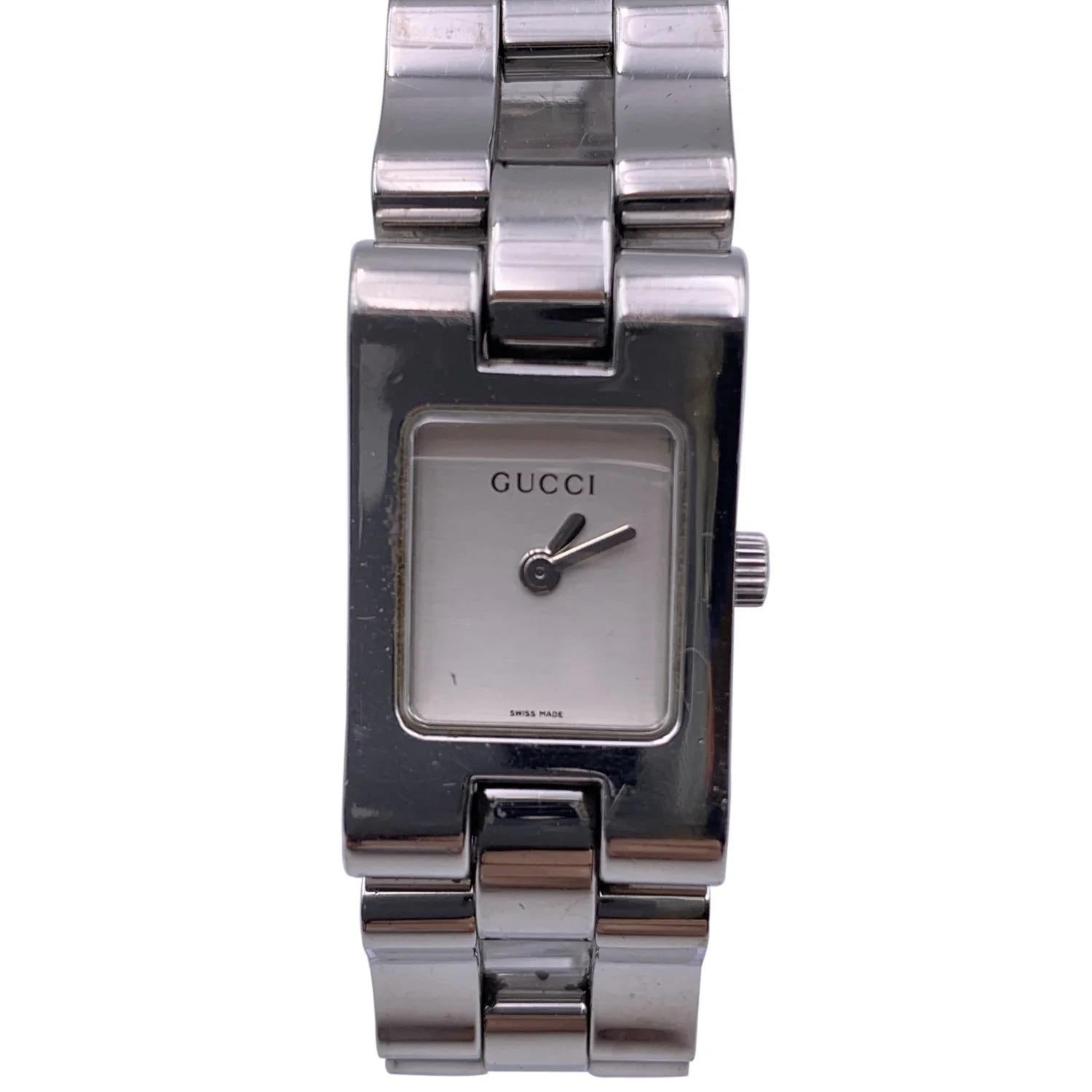 Gucci 2305L stainless steel wrist watch. Stainless steel case (Approximately 28 mm x 17 mm). White Dial and Sapphire crystal. Swiss Made Quartz movement. Gucci written on face, clasp & reverse.Water Resistant to 3atm. Deployant Clasp. Swiss Made.