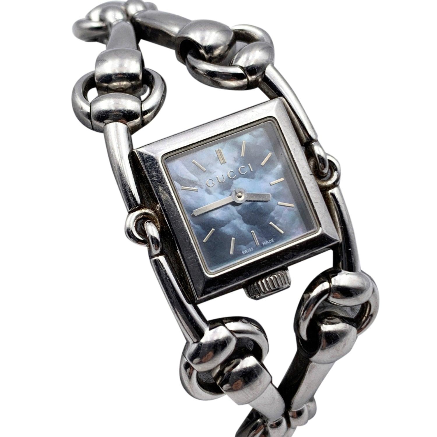 Gucci Mod. 'Signoria - 116.5' stainless steel wrist watch. Stainless steel case. Square mother of Pearl dial in blue color. Sapphire crystal. Swiss Made. Quartz movement. Horsebit bracelet. Gucci written on face, clasp and reverse. Will fit up to