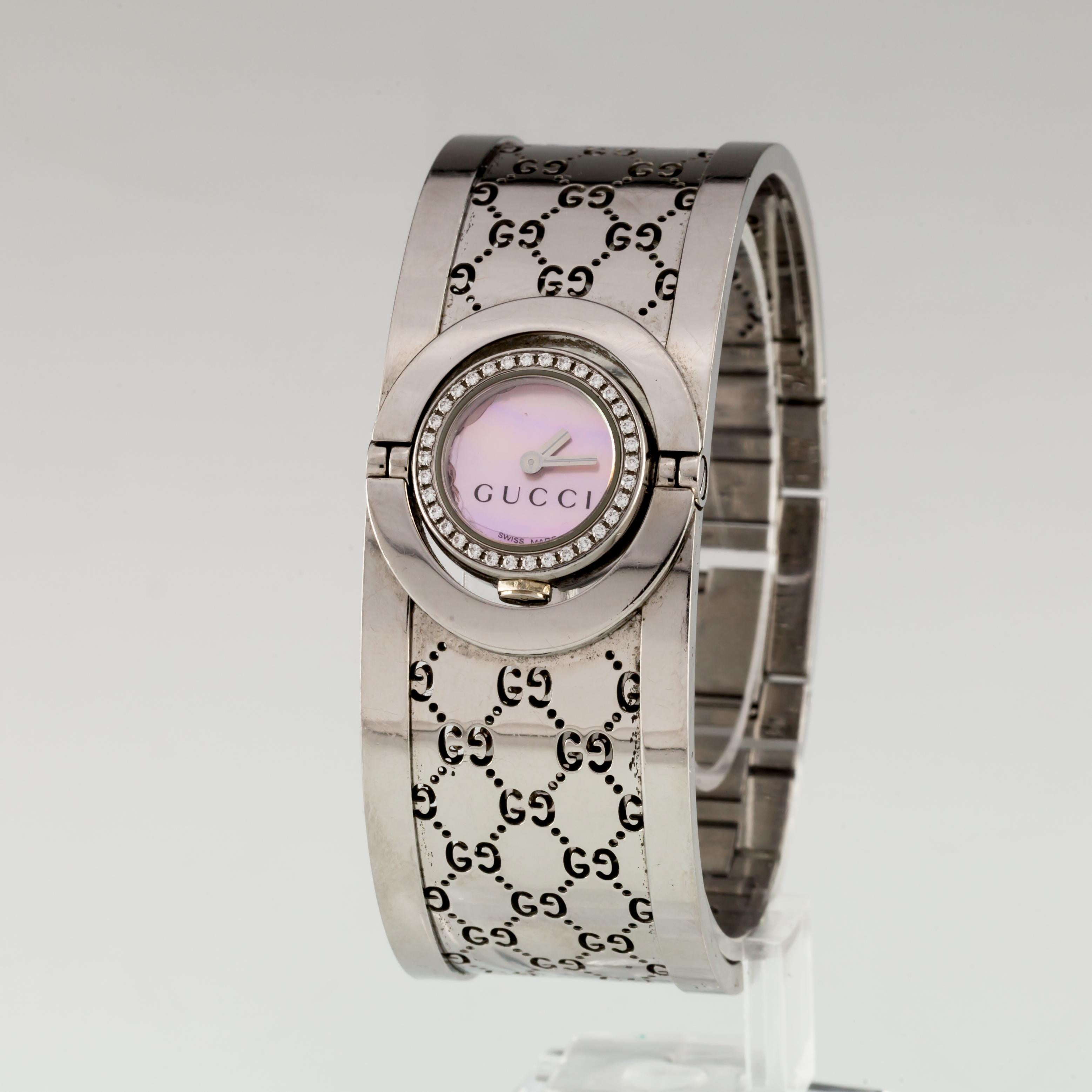 Gucci Stainless Steel Twirl Watch w/ Diamonds and MOP Dial w/ Box and Papers
Movement #1042
Case #3246

Stainless Steel Rotating Round Case w/ Diamond Bezel
16 mm in Diameter (17 mm w/ Crown)
Lug-to-Lug Width = 23 mm
Thickness = 6 mm

Pink