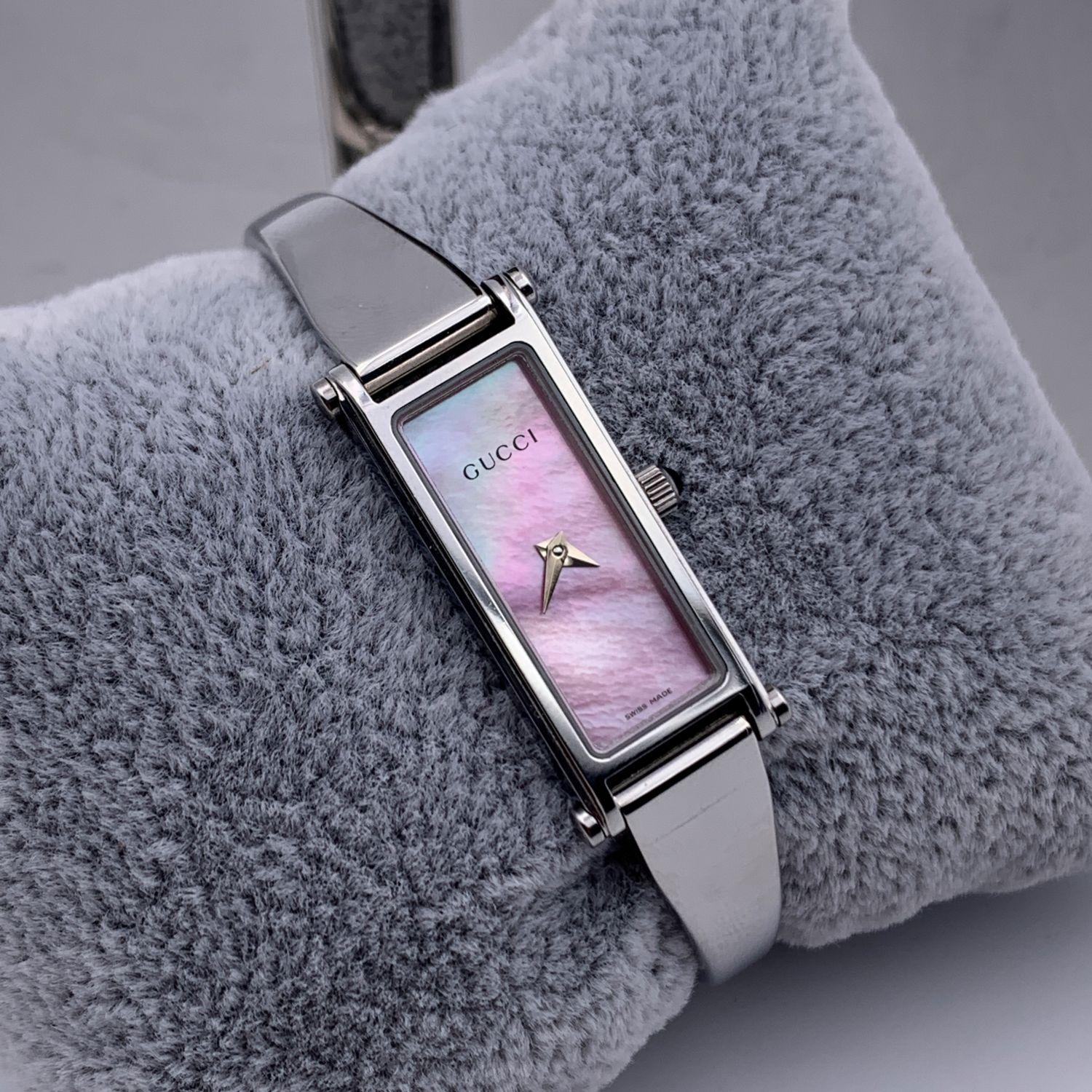 Gucci stainless steel ladies wrist watch. Model 1500L. Stainless steel case. Quartz movement. Water Resistant (up to 3 ATM). Mother of pearl pink dial. Swiss Made. Gucci written on the face, clasp & reverse. Clasp with snap closure (see images).