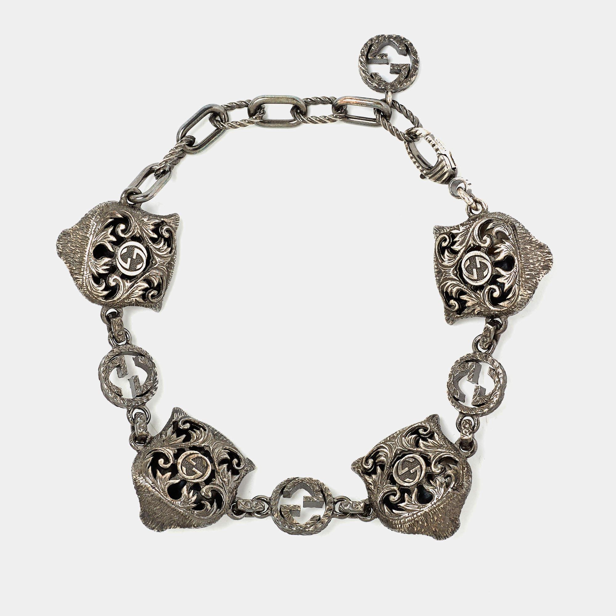 Be it to your dinner outfit or summer dress, this Gucci bracelet will surely add a statement touch. It is crafted from silver and added with feline head charms and the GG logo.

Includes: Original Dustbag, Original Box,
