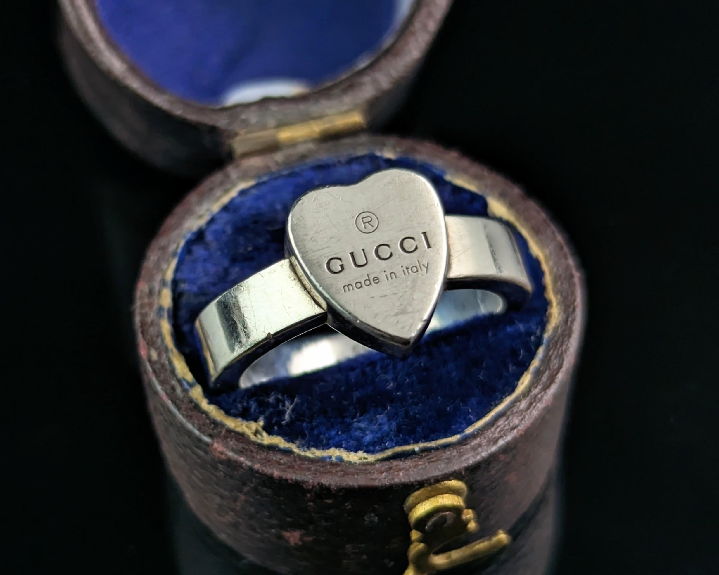 A stylish Gucci sterling silver heart trademark ring.

A classic and timeless piece from the 2000s, it is a chunky band style ring similar to a signet ring with a heart shaped face. 

A good solid piece, it comes with the original Gucci box and dust
