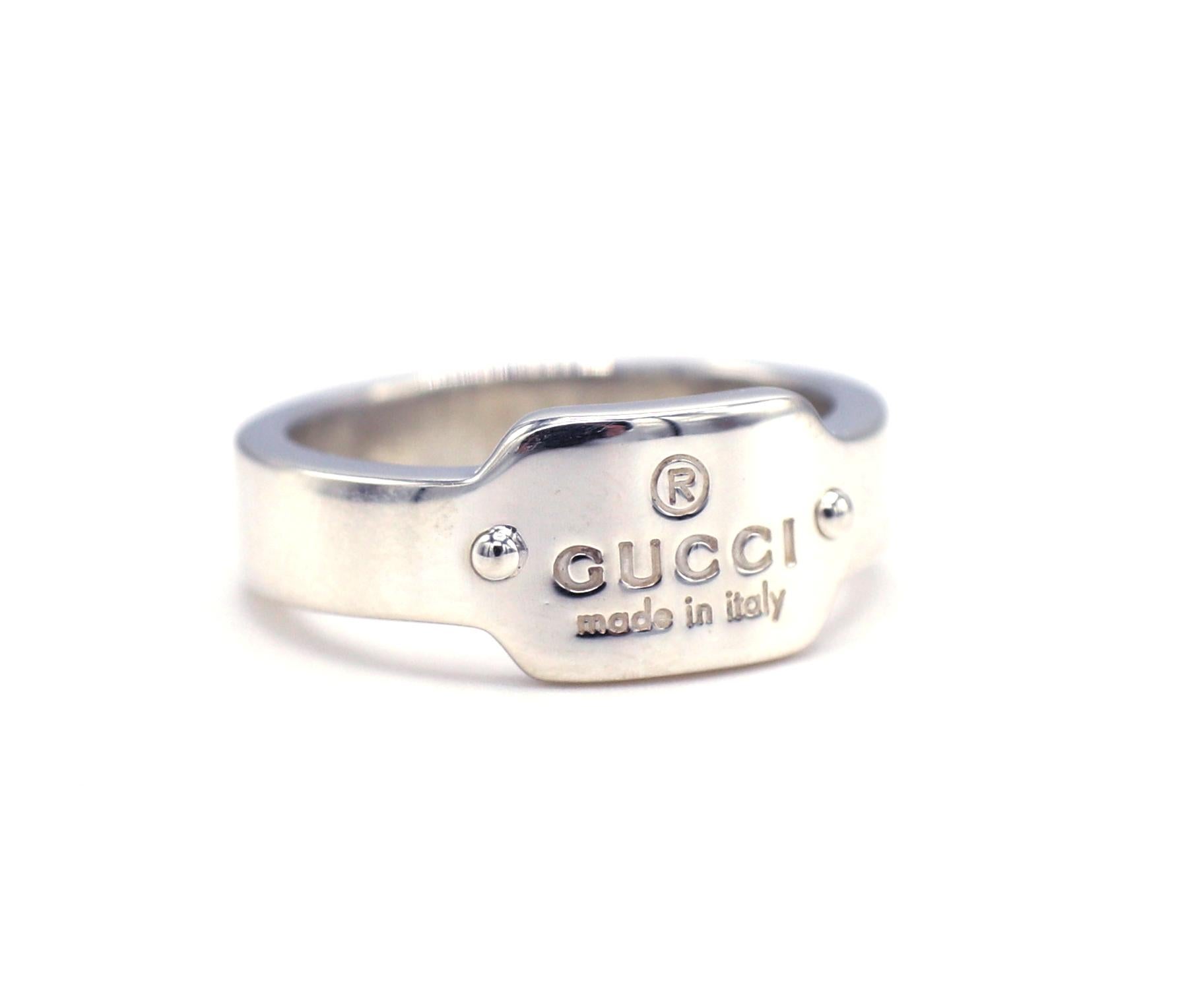 GUCCI Sterling Silver Logo Band Ring 
Metal: Sterling silver
Weight: 6.12 grams
Width: 4.8 - 8.2mm
Size: 6.5 (US)
Signed: GUCCI Made in Italy 
