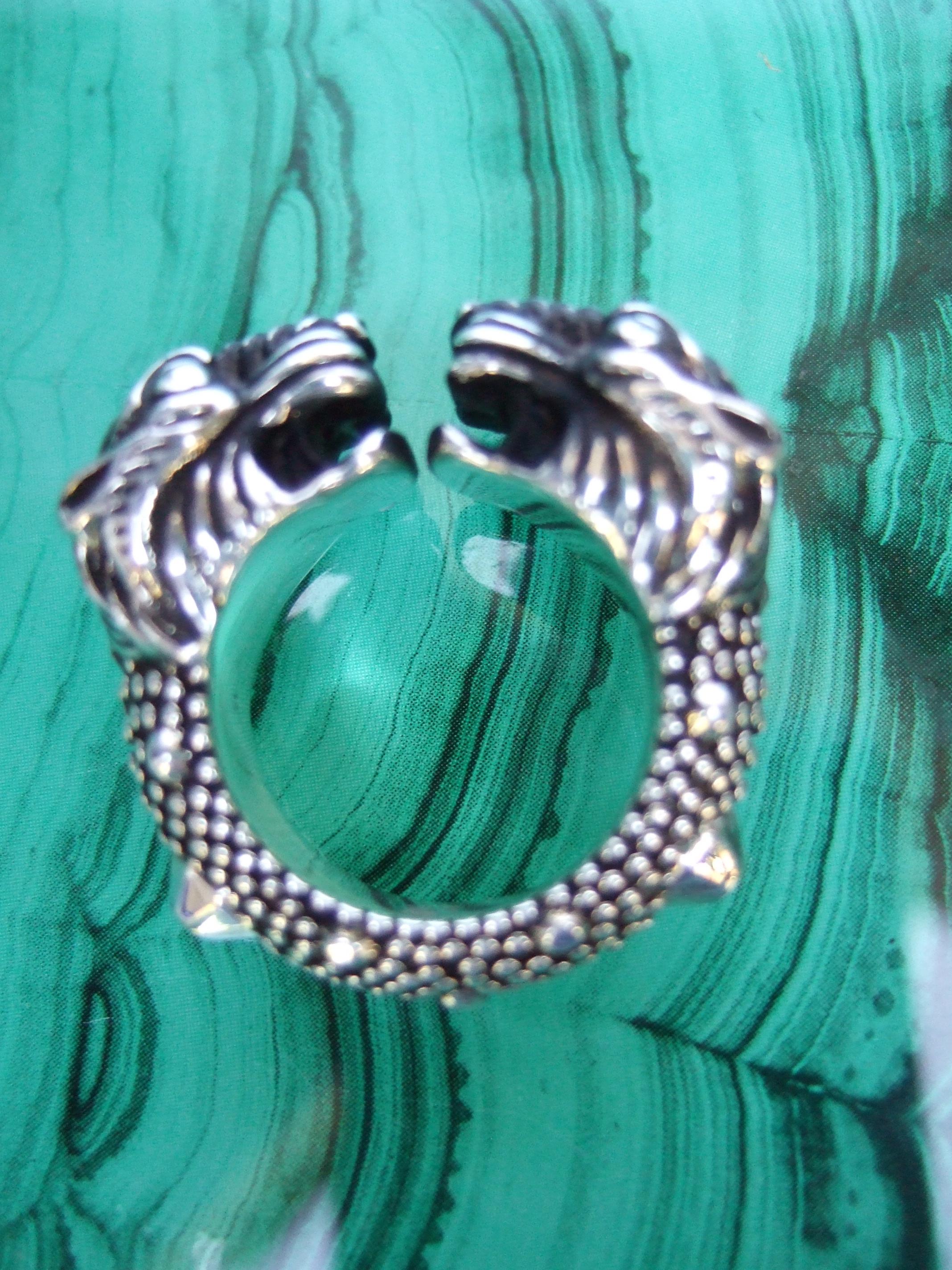 Gucci Sterling silver tiger's head ring in Gucci box Size 7 
The Italian sterling silver Gucci ring is designed with a pair of stylized
tiger's heads that converge at the center with a small gap opening 

The sterling silver has grooved and
