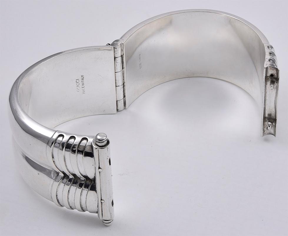 Wide double ring bangle bracelet.  Made and signed by GUCCI.  Heavy gauge sterling silver.  Hinged clasp with safety chain.  1 1/3