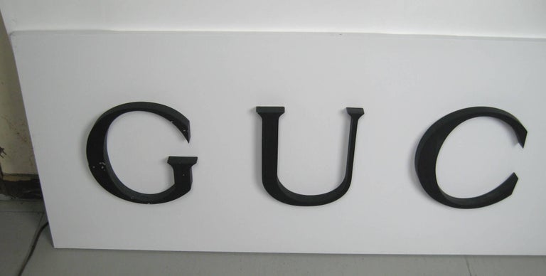 Original vintage sign from a Gucci store. Aluminum or sheet steel, circa 1980s. This will make a stunning decor piece. Be sure to check our storefront for many more decorating ideas, from primitives, machine age, Mid-Century Modern and many pieces