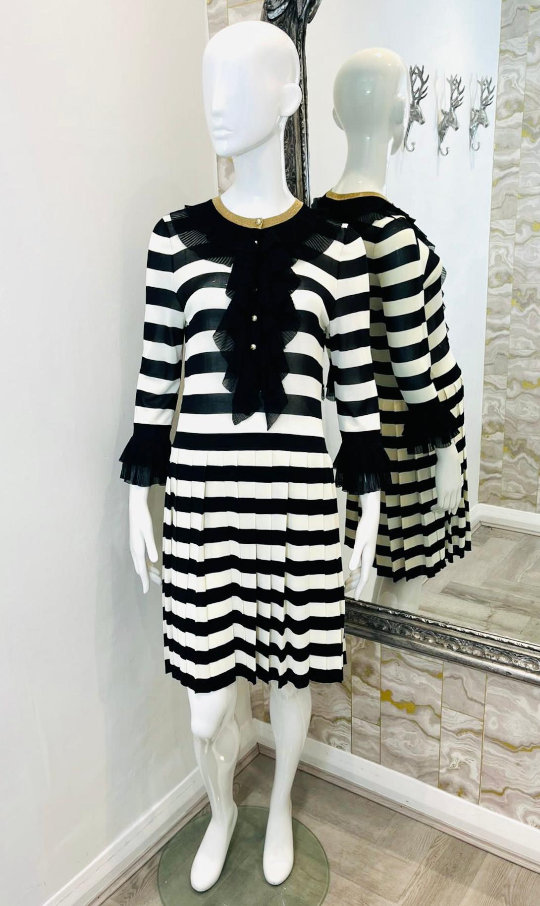 Gucci Striped Dress with 'GG' Pearl Buttons

Black & white dress designed with vertical striped pattern.

Detailed with gold 'GG' logo pearl buttons along the centre.

Featuring black lace ruffle accent to the neckline and cuffs.

Short, pleated