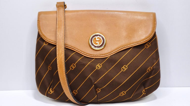 From none other than the house of Gucci! This takes the classic monogrammed bag and adds an interesting twist. The monogram is unique and fun with 'GG' embedded in slanted stripes in orange and printed on a rich brown canvas. The nylon fabric is