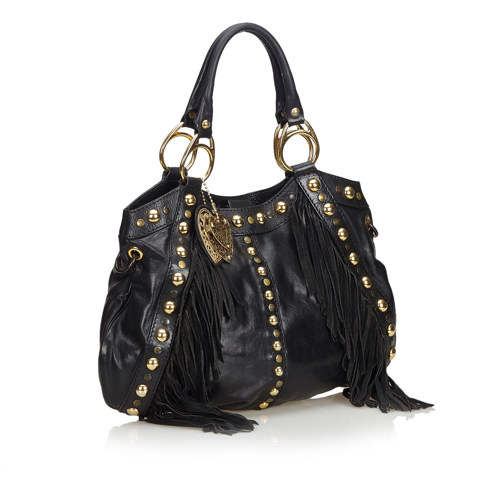 Gucci Studded Leather Babouska Fringe Satchel

This babouska satchel features a leather body, rolled handles, detachable flat strap, open top with magnetic snap button closure, fringe detail, and interior zip pocket. 

Approx. 

Length: 30 cm.