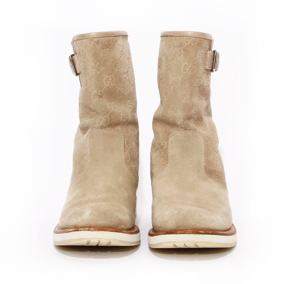 Suede monogram boot by Gucci 
Beige suede 
Tonal stitching 
Round toe 
GG monogram throughout 
Buckle side closure 
Slip-on
Made in Italy
Condition: Excellent, light scuffing and marks on sole. Pilling in suede. wear consistent with age and use (see