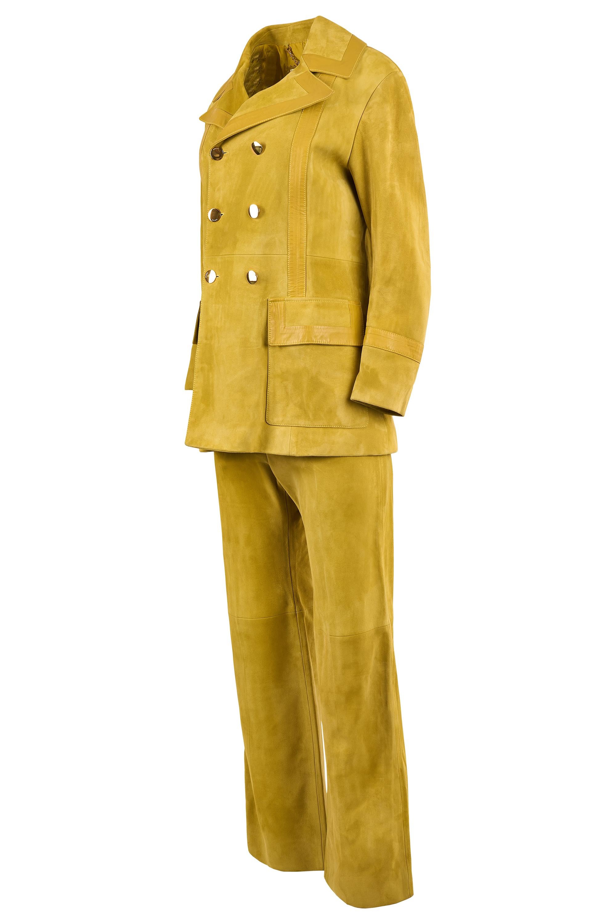 Set coordinato Gucci. Presenta un corpo in pelle scamosciata color senape, una giacca strutturata a doppio petto con ampi revers a lancia, bottoni dorati, tasche frontali con patta e una tasca interna. I pantaloni a vita alta abbinati hanno una