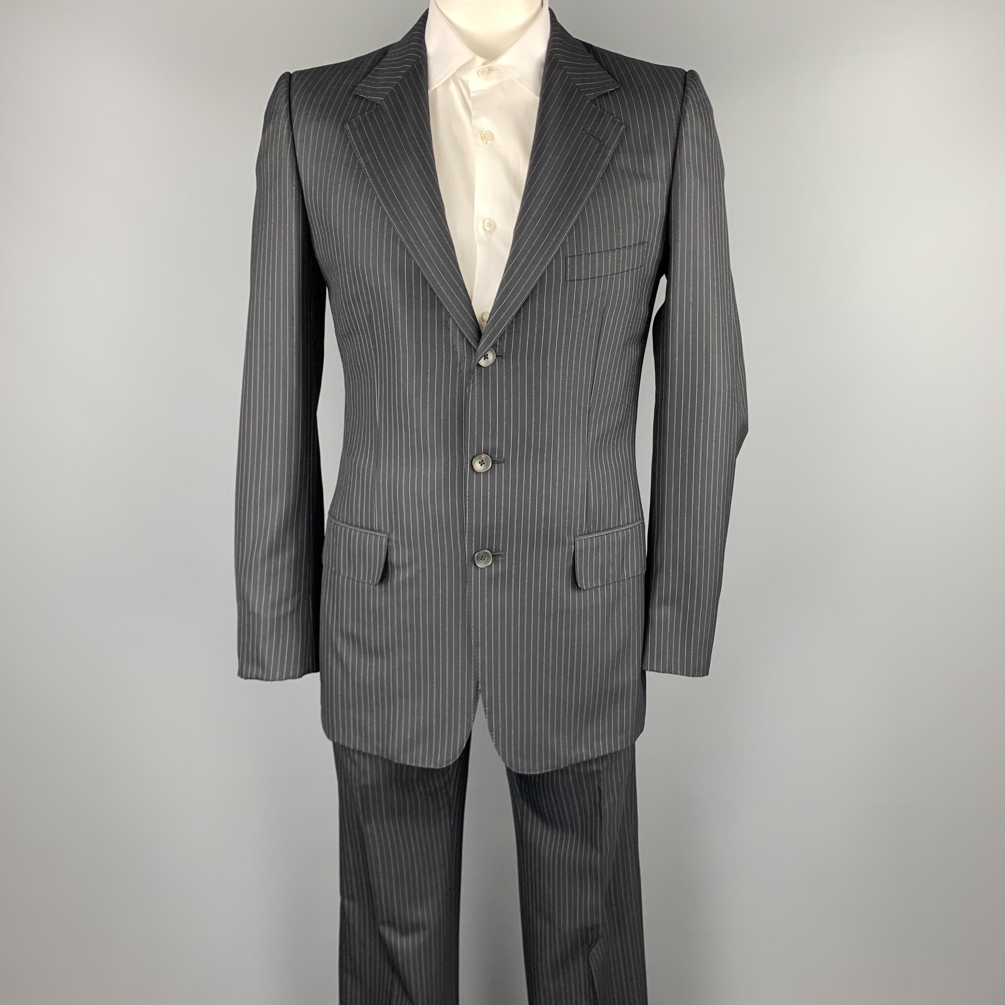 GUCCI long suit comes in a black stripe wool /silk and includes a single breasted, three button sport coat with notch lapel and matching flat front trousers. Made in Italy.

Excellent Pre-Owned Condition.
Marked: 50

Measurements:

-Jacket
Shoulder: