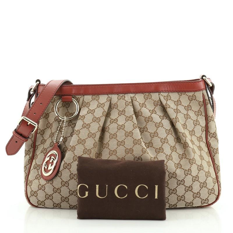 This Gucci Sukey Messenger Bag GG Canvas Medium, crafted in brown GG canvas, features adjustable leather strap, pleated details, and gold-tone hardware. Its zip closure opens to a neutral fabric interior with zip and slip pockets. 

Estimated Retail