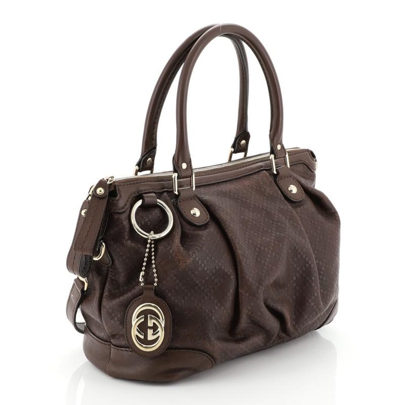 This Gucci Sukey Top Handle Satchel Diamante Leather Medium, crafted from brown diamante leather, features dual rolled handles and gold-tone hardware. Its two-way zip closure opens to a neutral fabric interior with side zip and slip pockets.