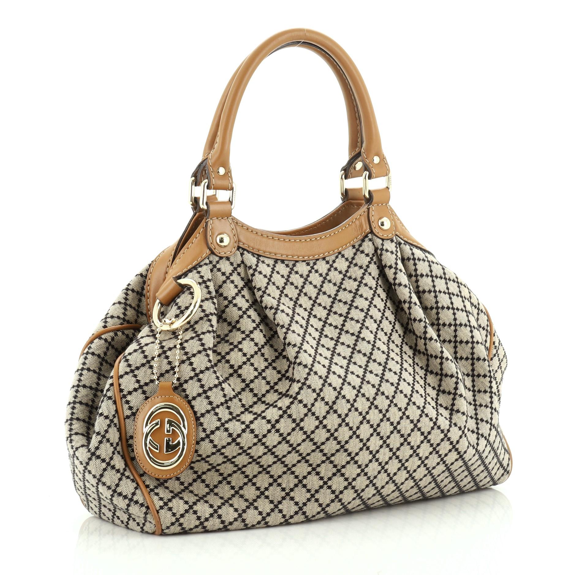 This Gucci Sukey Tote Diamante Canvas Medium, crafted from brown diamante canvas, features dual rolled leather handles and gold-tone hardware. Its magnetic snap closure opens to a neutral fabric interior with zip pocket. 

Estimated Retail Price: