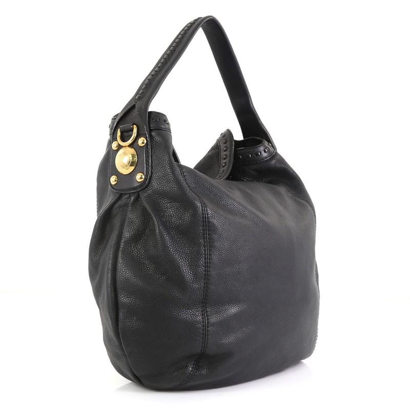 This Gucci Sunset Hobo Leather, crafted in black leather, features a flat leather handle and gold-tone hardware. Its wide open top showcases a black fabric interior. 

Estimated Retail Price: $1,400
Condition: Very good. Minor wear on exterior,