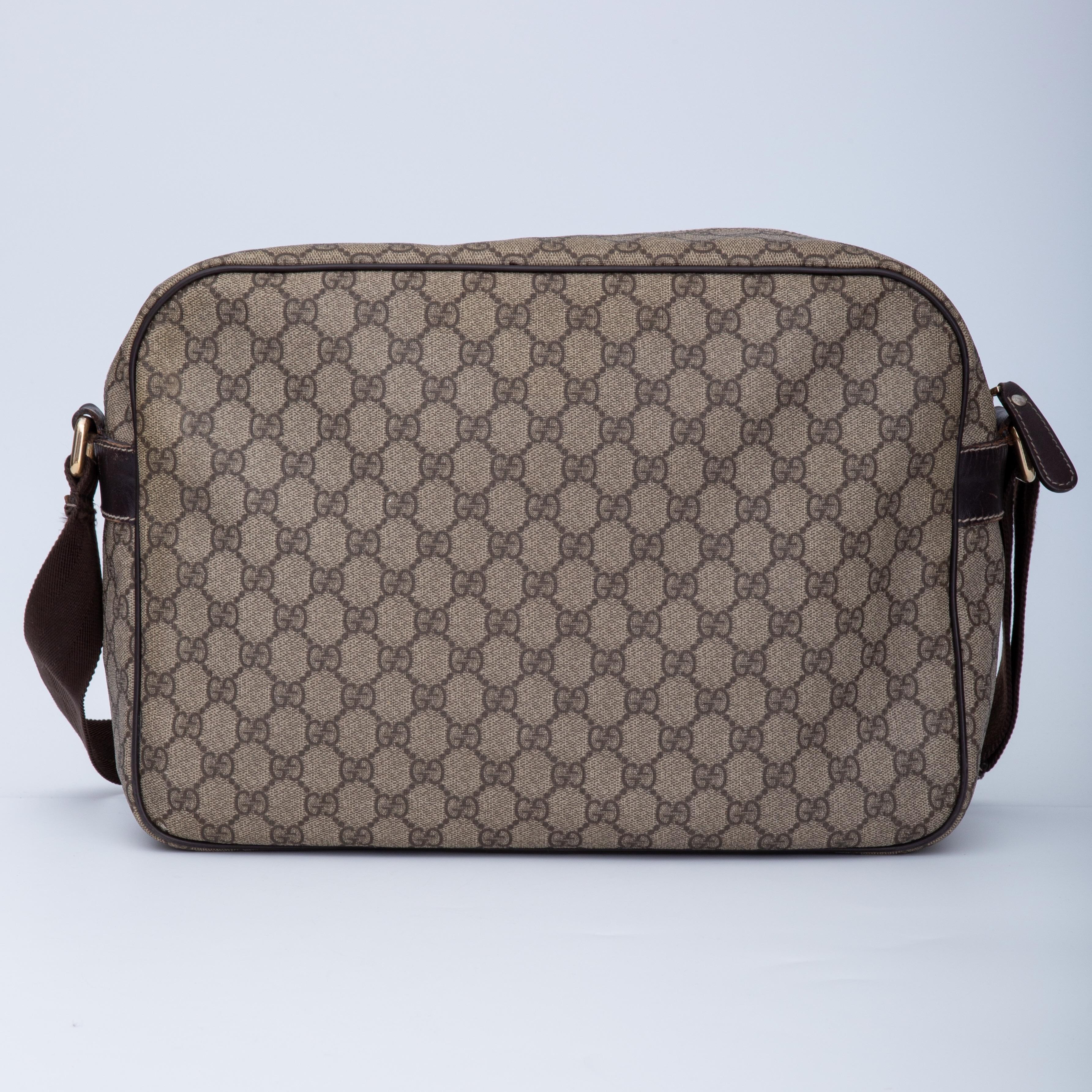 The bag features an exterior of durable GG Supreme coated canvas, leather trim and details, an adjustable canvas strap, top zip closure, brown woven fabric interior with slip pockets and a front zipper compartment.

The messenger bag can be worn on