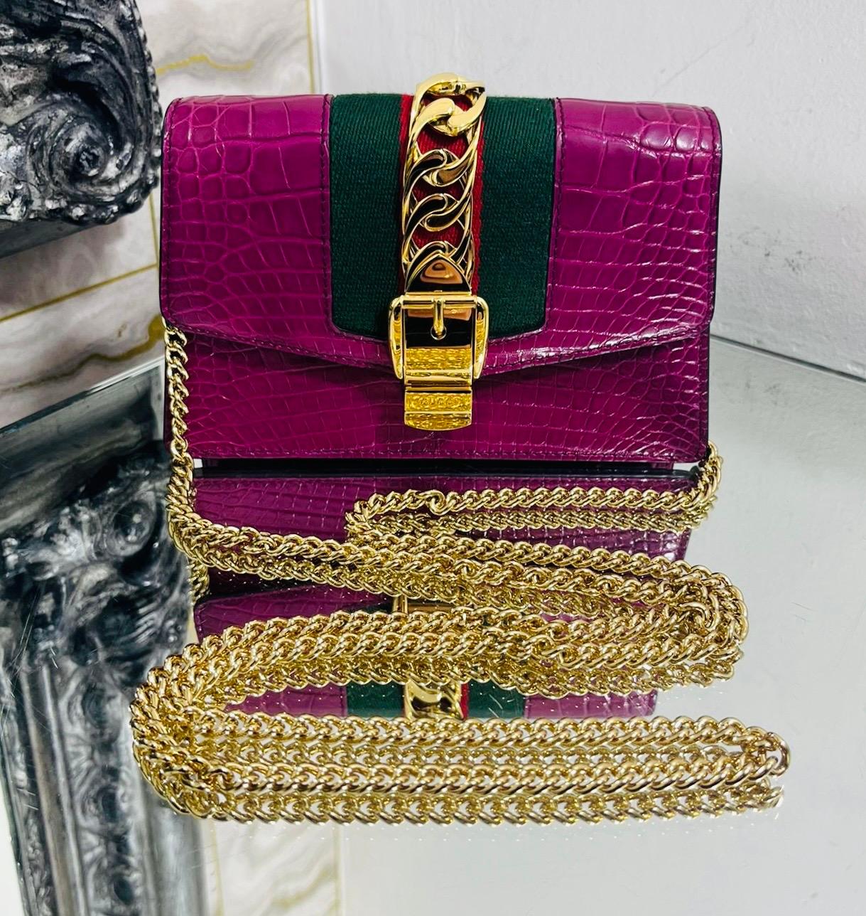 Brand New - Limited Edition - Gucci Sylvie Alligator Skin Web Stripe Bag

Purple exotic leather bag fully crafted from alligator skin.

Detailed with chunky gold chain link buckle snap closure with 'Gucci' engravement.

Featuring signature