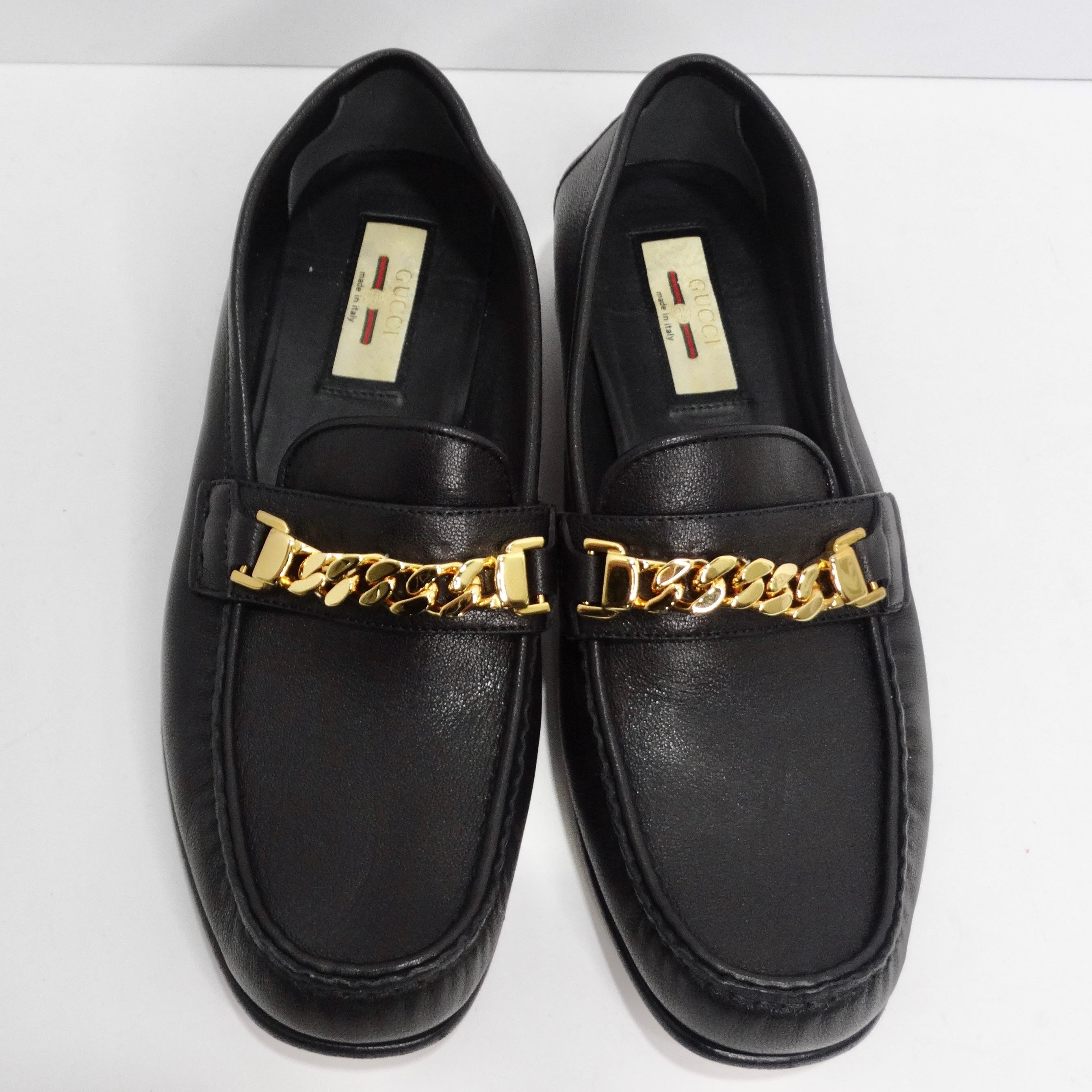 Introducing the Gucci Sylvie Gold Tone Chain Loafers in Black Leather, a timeless and versatile addition to your footwear collection that effortlessly combines classic style with a touch of luxury. These black leather loafers are a true embodiment