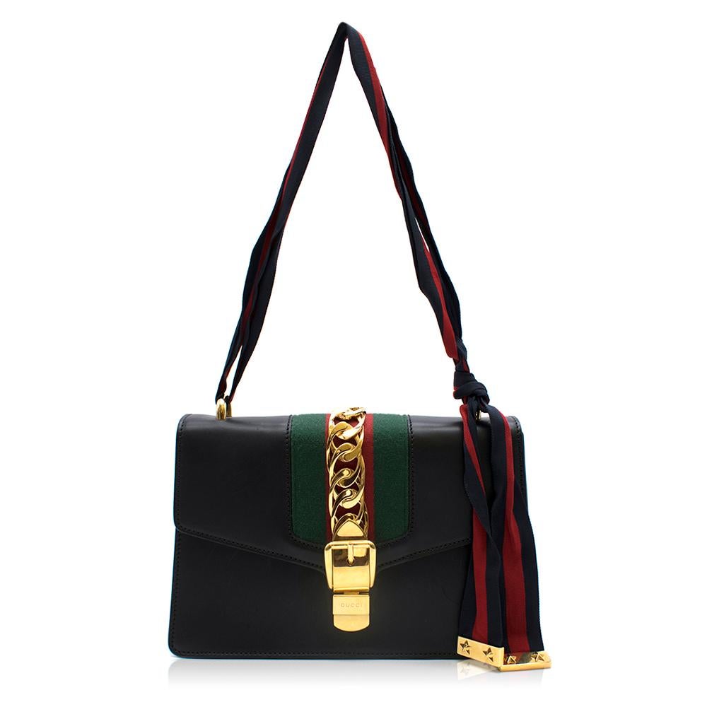 The Sylvie bag combines a playful mix of House codes. Comes with a blue and red shoulder strap and gold buckle. The signature Gucci shape from the '60s and '70s is brought back from the archives in a modern version. 

- Made in Italy
- Black