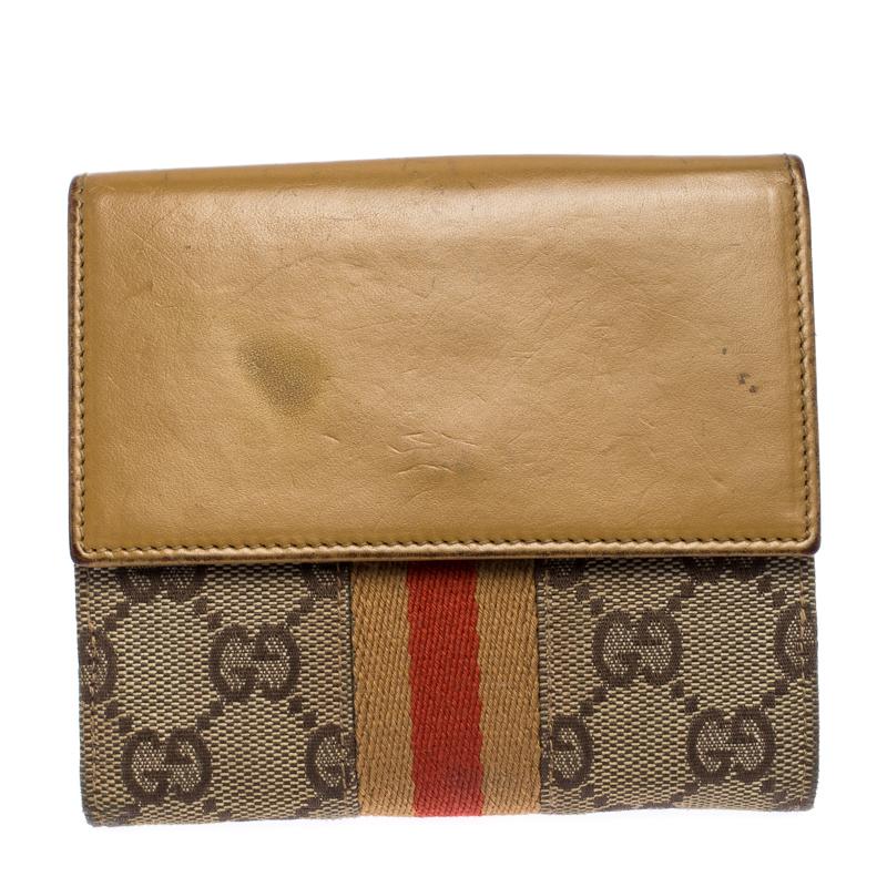 Wallets like this one from Gucci are a necessity since they're not only functional but also stylish. Crafted from GG canvas and adorned with a signature lock, this compact wallet has dual openings. Where the front is designed in a bifold style with
