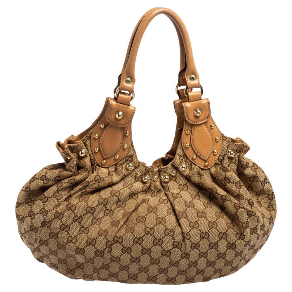 Take your style a notch higher with this Pelham hobo from Gucci. Sewn using GG canvas and leather, the bag features two leather handles, a spacious fabric interior, and gold-tone hardware. This hobo is perfect for daily use.

