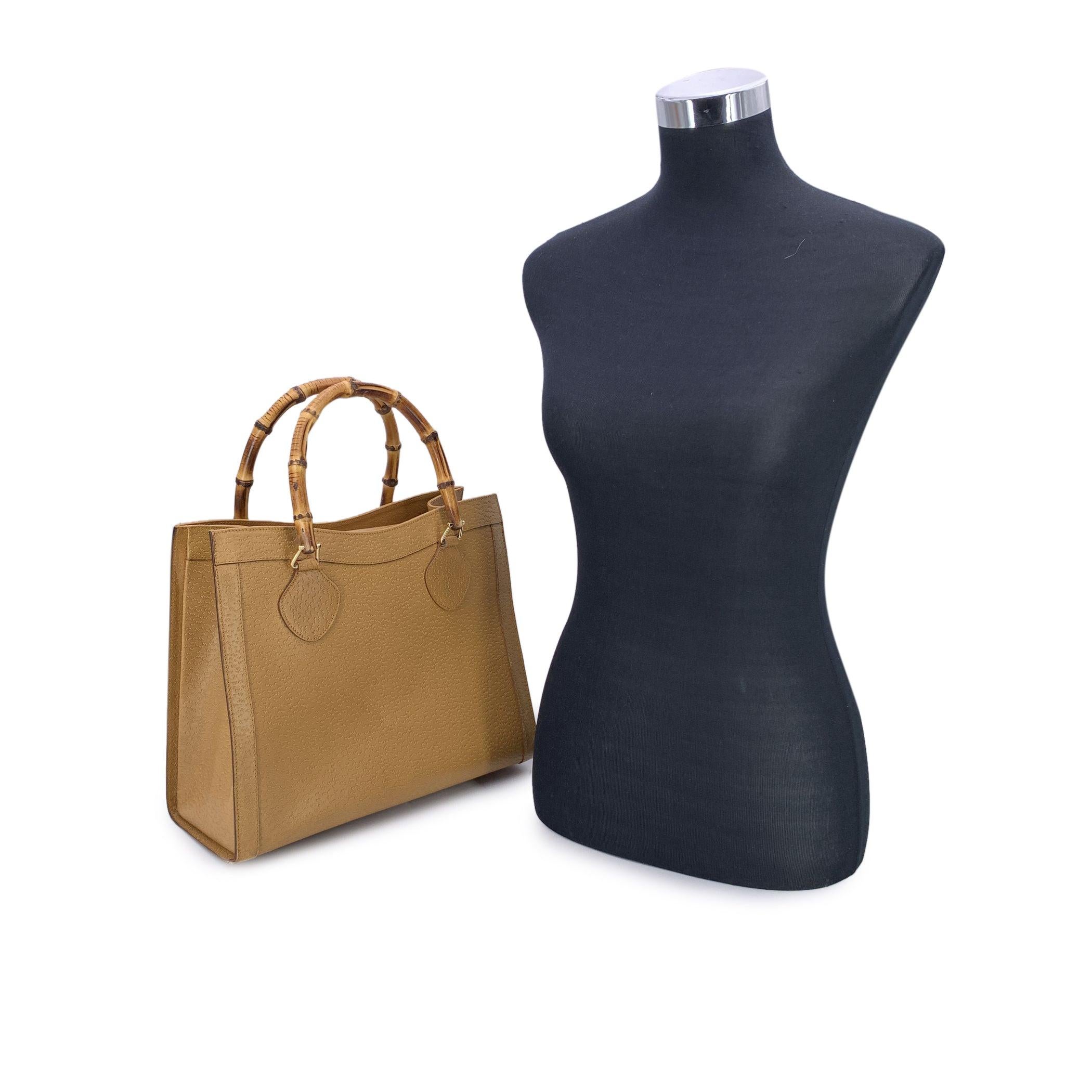 Step into the world of timeless luxury with this stunning Gucci Bamboo tote bag, a true testament to elegance and craftsmanship. The rich tan-brown leather exudes sophistication, while the double distinctive bamboo handles offer a unique touch of