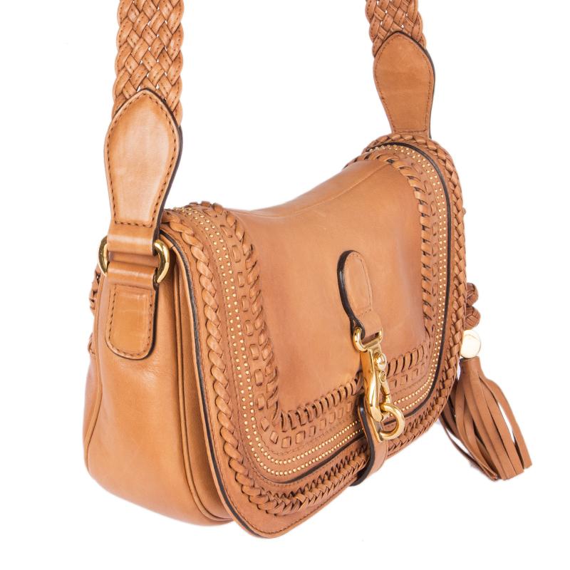 Gucci limited edition 'Marrakech Messenger' shoulder bag in natural tan leather with braiding and studs. Closes with a clasp on the front. Lined in dark brown suede with two open pockets against the front and a zipper pocket against the back. Has