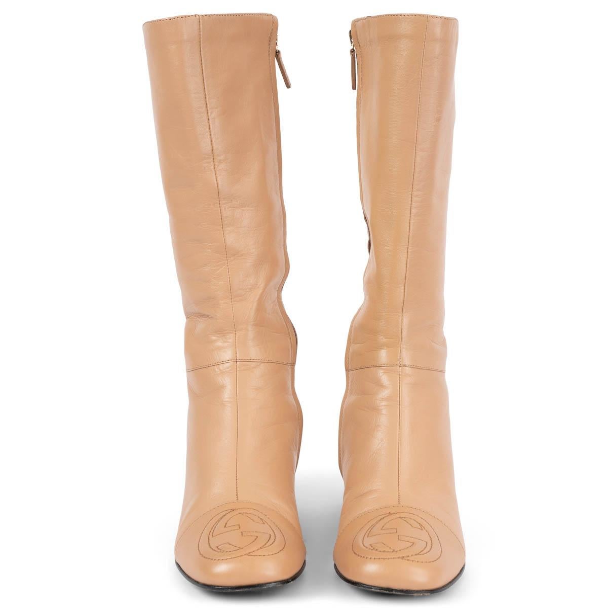 100% authentic Gucci block-heel mid-calf boots in tan smooth leather. The design features a stitched GG logo in the cap toe and open with a zipper on the inside. Have been worn and are in excellent condition. 

Measurements
Imprinted Size	37
Shoe