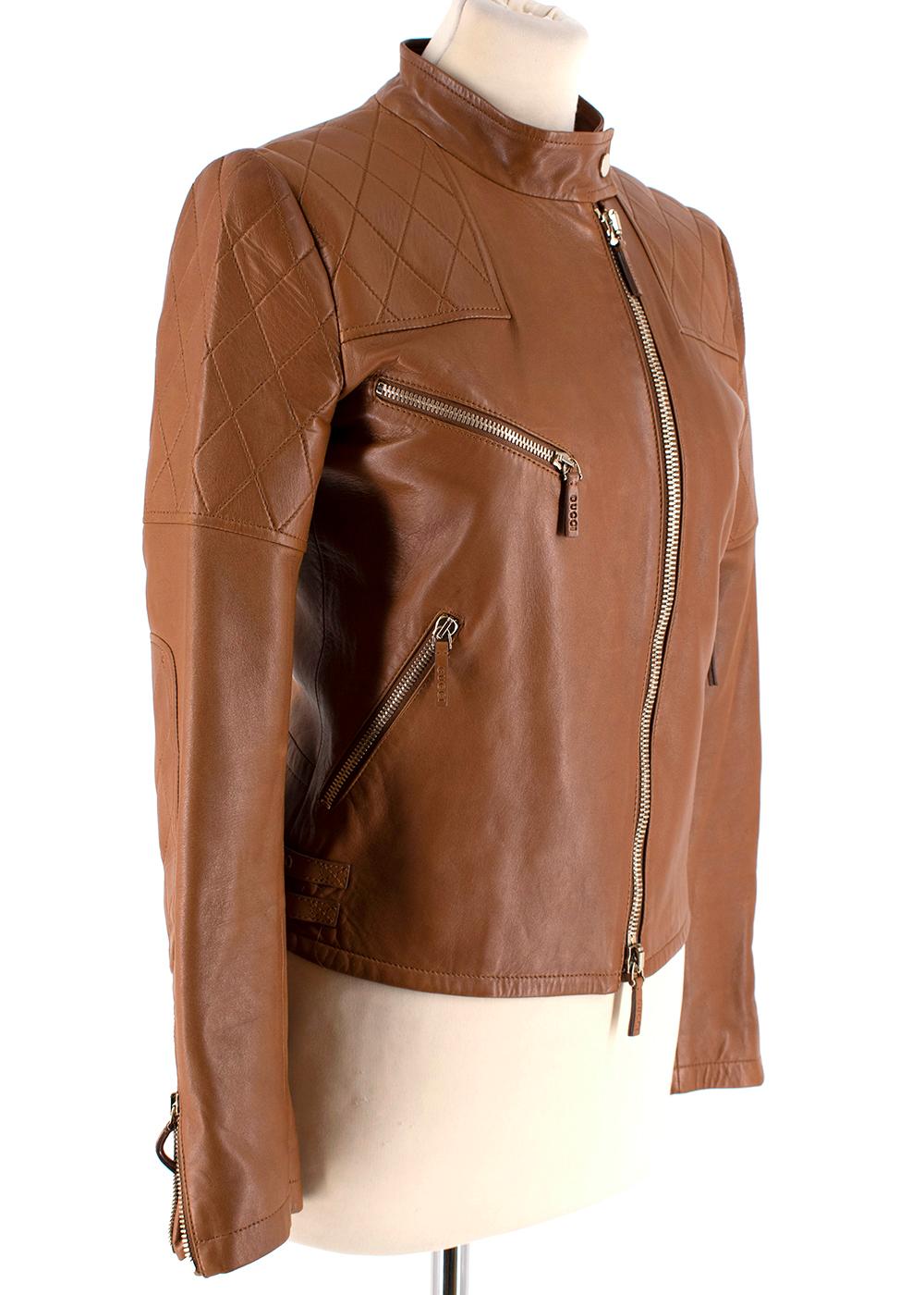 Gucci Tan Leather Asymmetric Biker Jacket

- Quilted pattern on the upper body and patched elbows
- Gold zipped hardware
- Soft lambskin
- Zipped side pockets (X3)
- Gucci embossed zip tassels
- Side belt detailing in gold to accentuate the hips
-