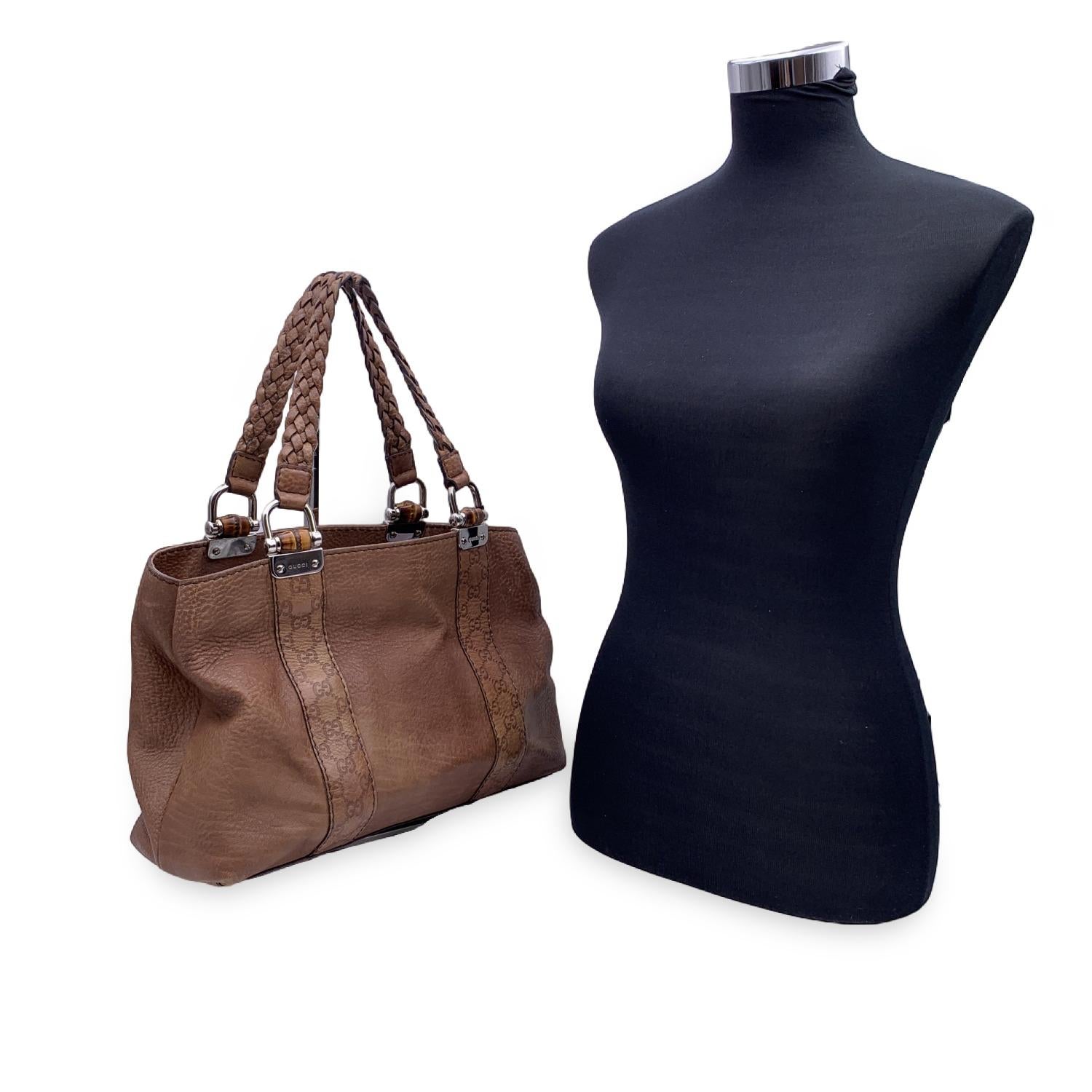 Beautiful Gucci tote in tan leather.  It featured Guccissima leather trim, bamboo details and braided leather handles. Open top. 2 main sections and 1 misslde zip compartment inside. Brown fabric lining. 1 side zip pocket inside. 'Gucci - Made in