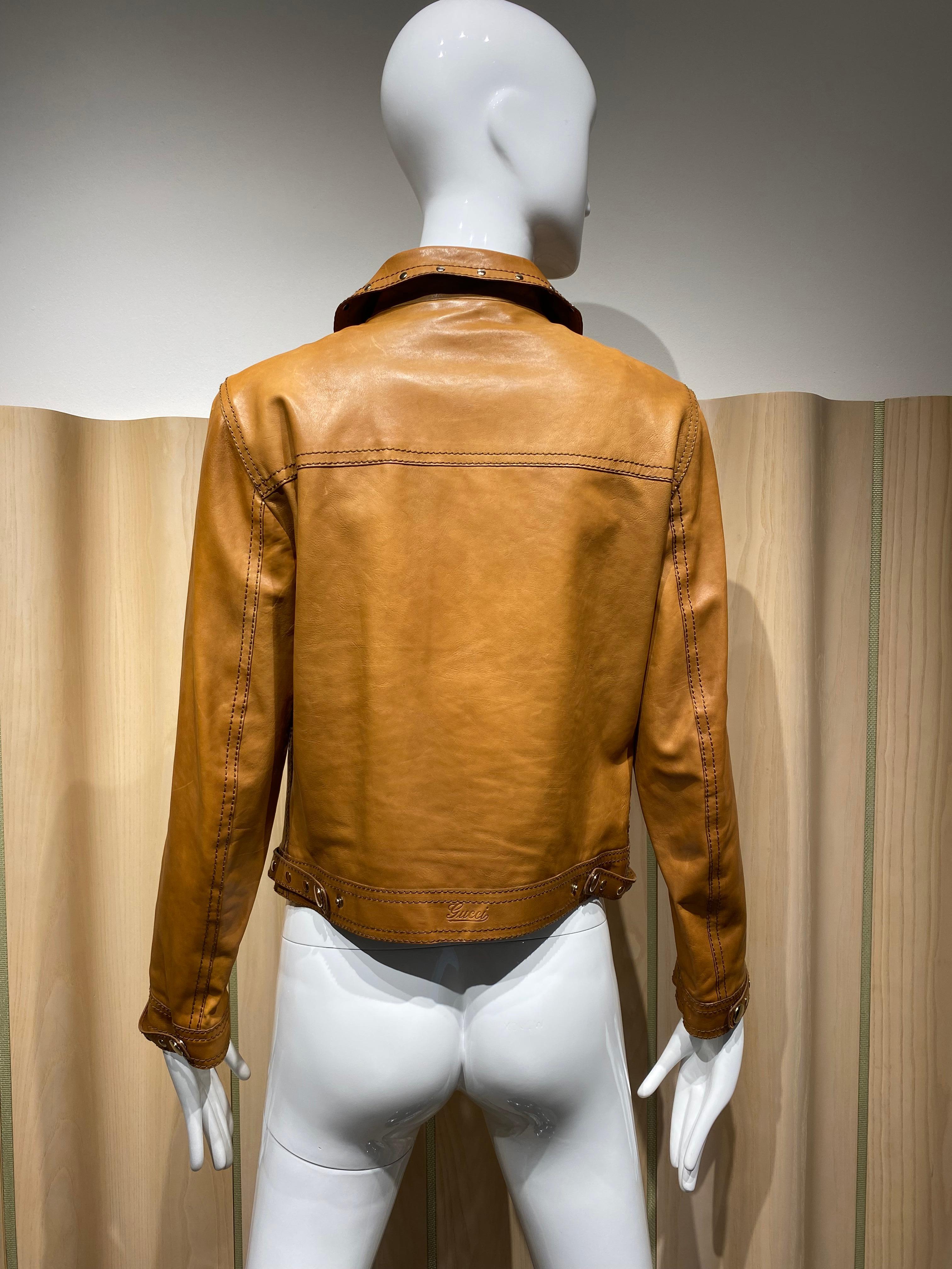 Gucci Tan Leather Jacket lined in Gucci logos. 
Marked size 42 IT
Measurement: Shoulder 16” / Bust 34” / Waist 34” / Hip 34” / Sleeve length: 23”/  Jacket length 19”
