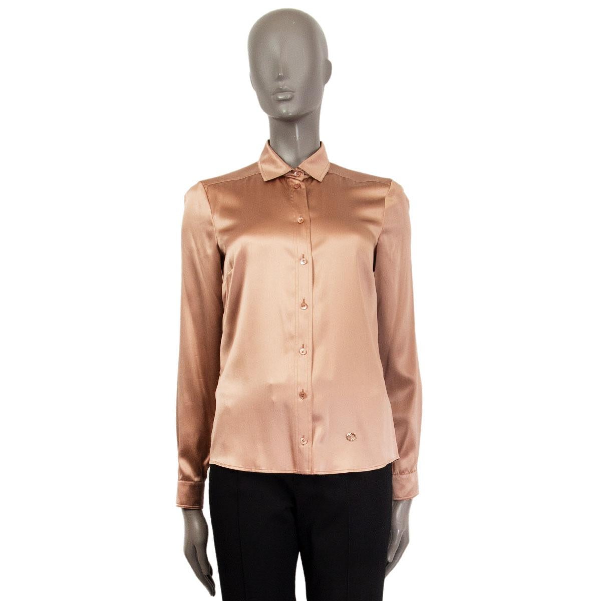 100% authentic Gucci satin long sleeve shirt in tan silk (96%) and elastane (4%). Closes with eight buttons on the front and with a GG silver-tone metal logo on the left-side bottom. Unlined. Has been worn and is in excellent