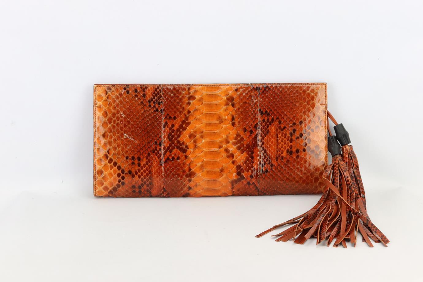 Gucci tasselled python and leather clutch. Made from orange python and leather with bamboo tasselled detail, it has a large compartment with two zip pockets. Orange. Magnetic fastening at top. Does not come with dustbag or box. Height: 6.5 in.