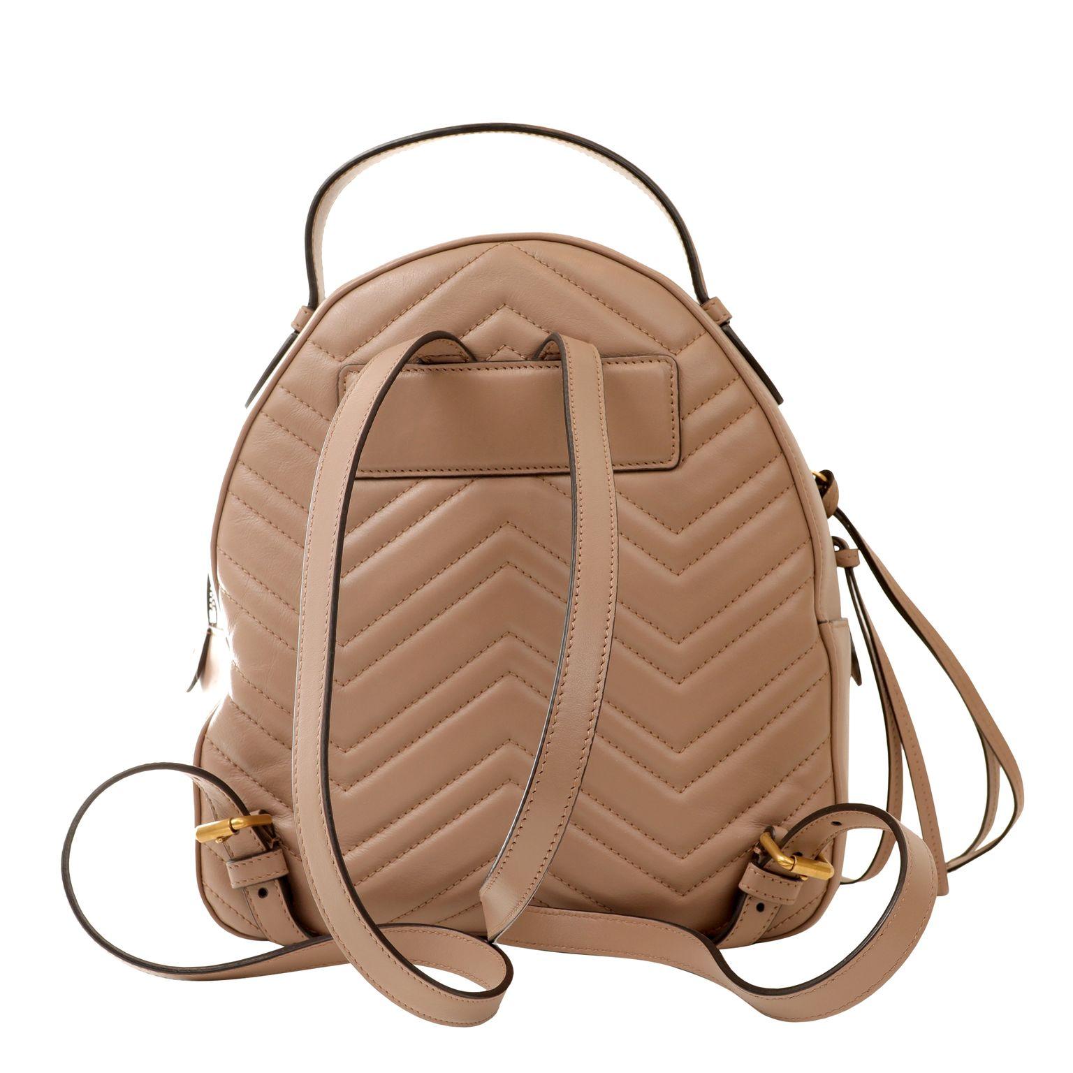 This authentic Gucci Taupe Leather GG Marmont Backpack is pristine.  Taupe leather backpack is stitched with chevron pattern.  Gold tone large GG insignia.  Adjustable straps and zippered access. Dust bag included.

PBF 14031