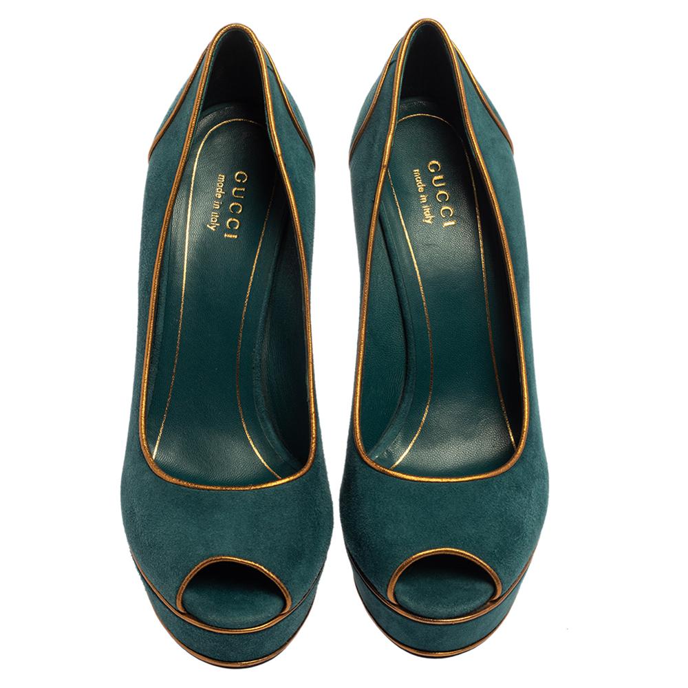 Brimming with unparalleled sophistication, these lovely pumps from Gucci are ready to help you touch the skies! Rendered in luxurious teal green suede with gold leather piping and flaunting a peep-toe silhouette, these pumps offer comfort with their