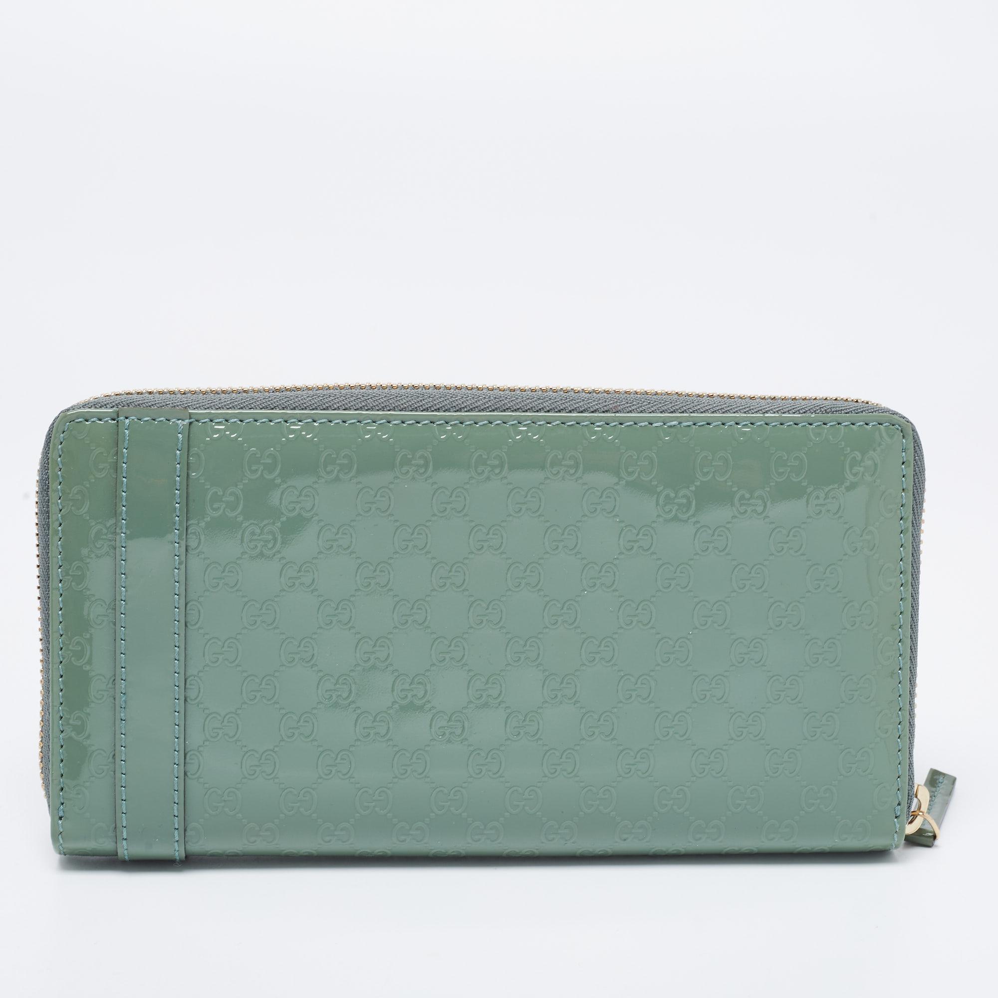 Ensure your essentials are in a secure place with this wallet from Gucci. Crafted using teal green, Microguccissima patent leather, this wallet is decorated with gold-tone hardware and has a zip-around feature. It comes with a well-spaced interior