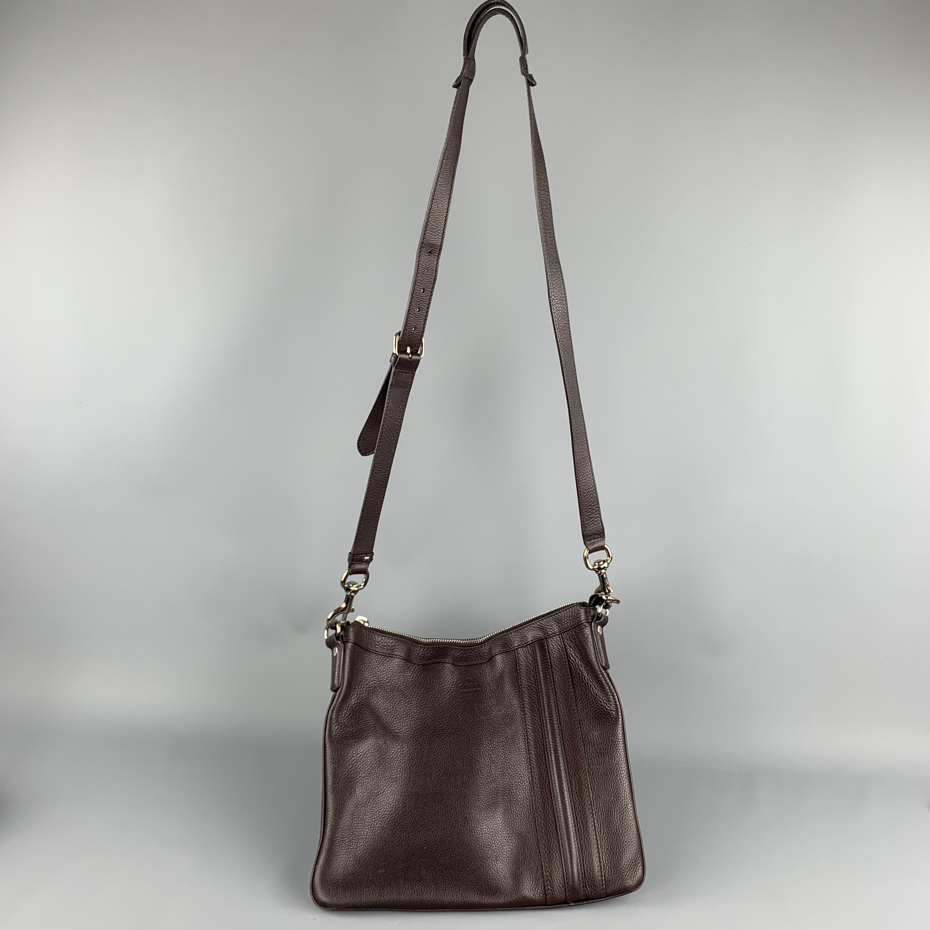 GUCCI crossbody bag comes in a textured chocolate brown leather with a logo stamped front pouch detailed with stripes and detachable strap. As is. Made in Italy.

Very Good Pre-Owned Condition.

Measurements:

Length: 13.5 in.
Width: 1 in.
Height: