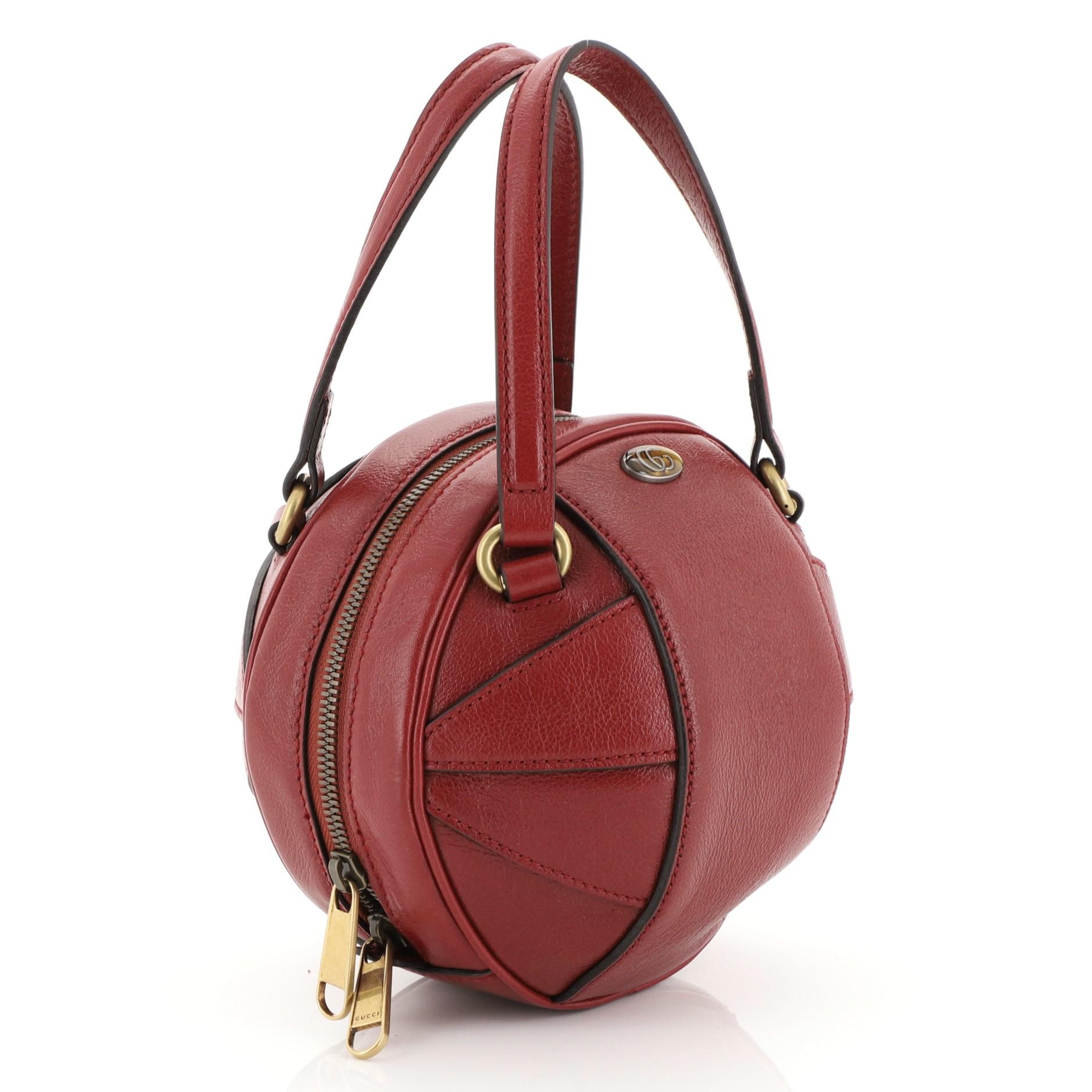 This Gucci Tifosa Convertible Shoulder Bag Glazed Leather Mini, crafted from red leather, features dual flat handles and aged gold-tone hardware. Its zip closure opens to a neutral fabric interior. 

Estimated Retail Price: $2,000
Condition: Very