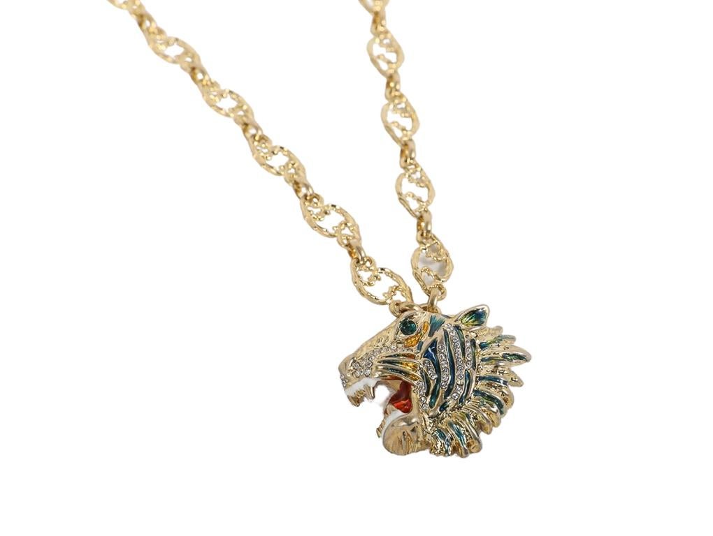 What a beautiful necklace by Gucci shaped in a tiger. Decorated with sparkling crystals and coloured enamel, the motif defines the pendant hanging from this chain necklace. Metal with gold finish. Enameled tiger head with crystals–inspired by a
