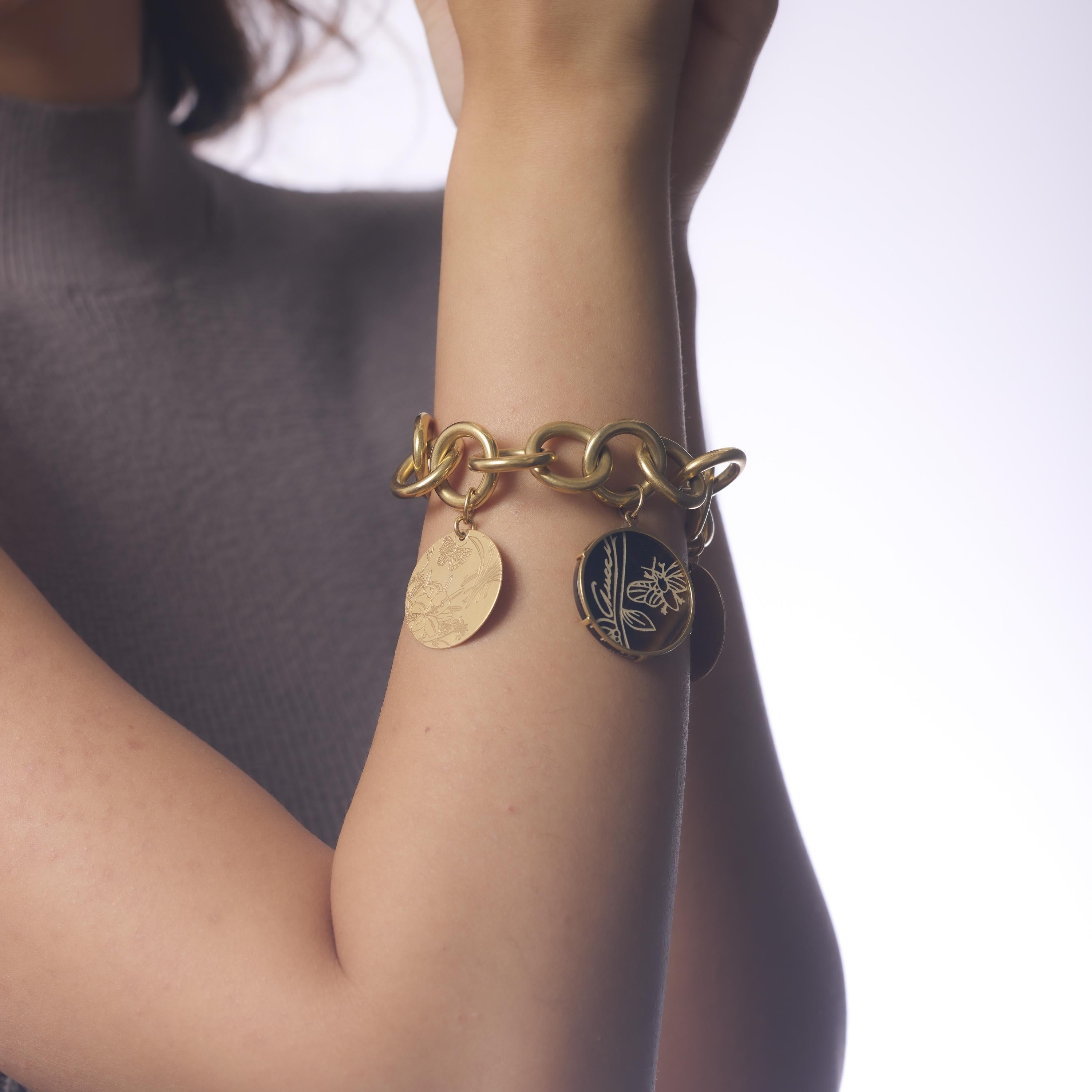 This Mid Century Gucci Flora St. Tropez bracelet features rich tiger's eye inlaid in gleaming 18k yellow gold, creating a warm, sculptural design. Signed and crafted in Italy during the 1960s, it’s a luxurious statement of vintage glamour and iconic