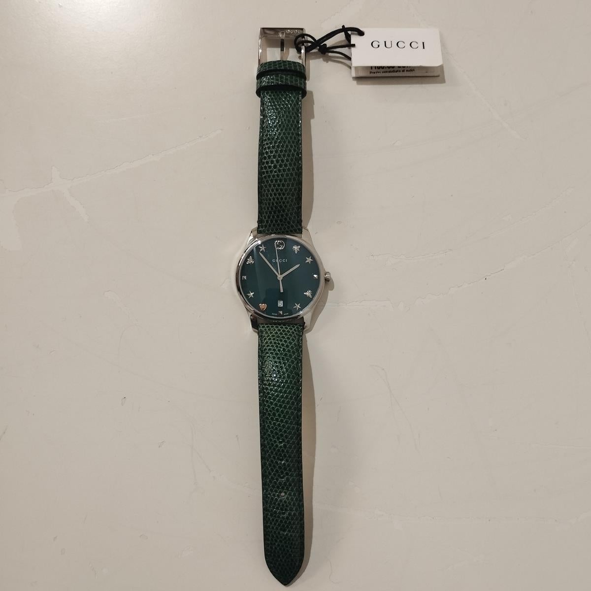 Beautiful and brand new Gucci watch
Timeless Watch
YA1264042
Steel 
Green mother of pearl dial
Glass
Quartz mechanism (brand new battery)
Water resistant
Case 36 mm
Green lizard printed leather bracelet 
With box
Original price € 1100
Worldwide