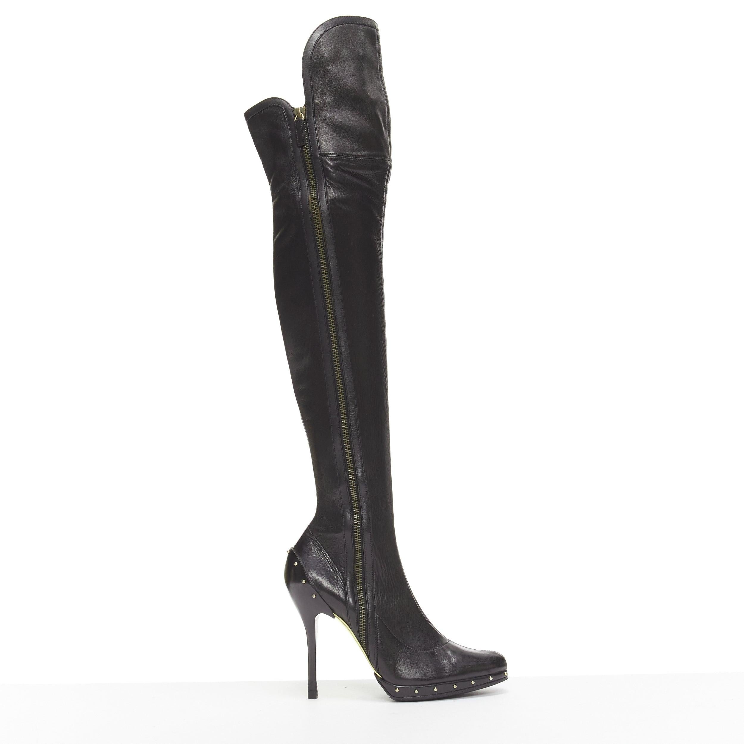 GUCCI TOM FORD 2003 Runway black leather studded thigh high boots EU37
Reference: NKLL/A00229
Brand: Gucci
Designer: Tom Ford
Collection: 2003 AW - Runway
Material: Leather
Color: Black, Gold
Pattern: Solid
Closure: Zip
Lining: Black Fabric
Extra