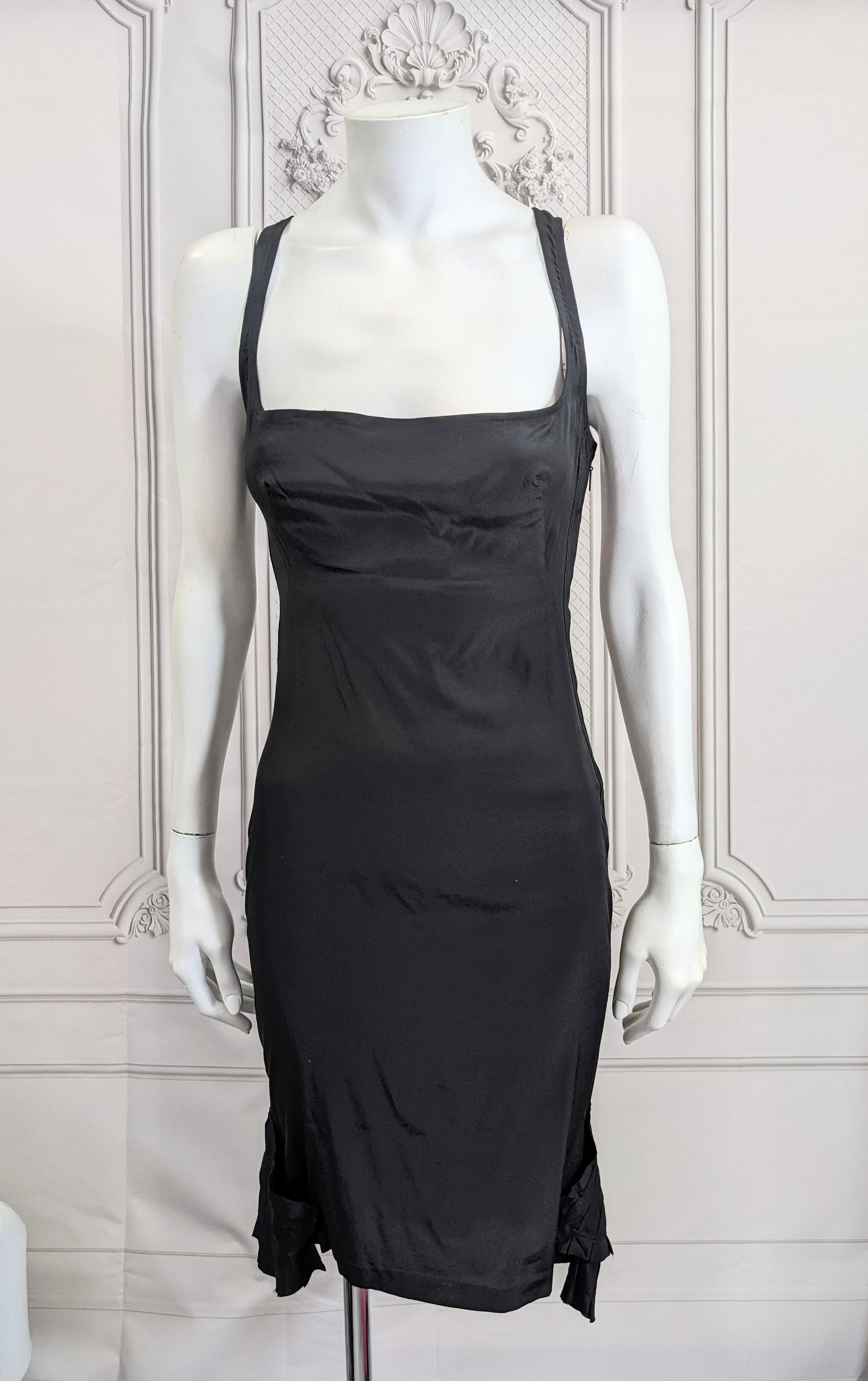 Gucci by Tom Ford Body Con Slip dress in black silk crepe with pleated fan hem. Very provocative unlined dress designed to sizzle. Simple racer back styling with a flourish a fan pleated motifs at the hem for added interest and movement. The side