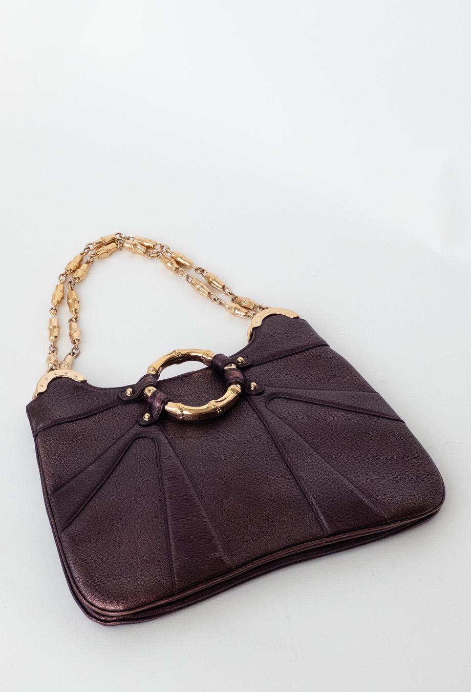 prémode presents Gucci Tom Ford Era 2004 Bag. This limited edition bag was designed by Tom Ford for his final collection as the Creative Director for Gucci. Featuring absolutely gorgeous metallic leather and intricate bamboo motif chain, this rare