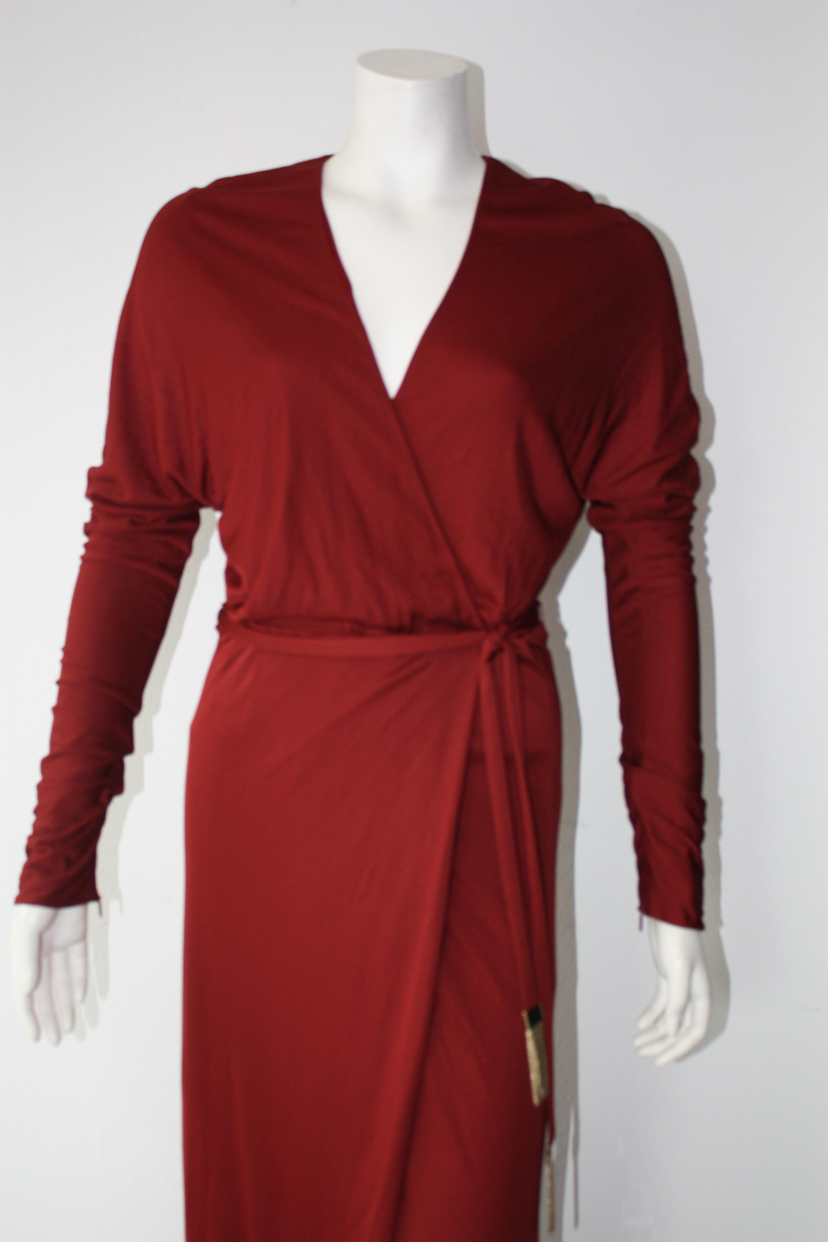 Gucci burgundy red long sleeve wrap evening gown. Tom Ford era. 
Sash with gold chain accents.

100% viscose.
Size 40
